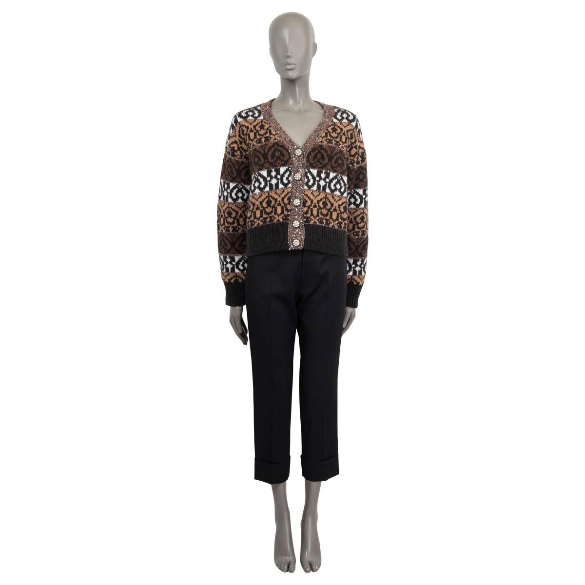 100% authentic Chanel 2019 sequin embellished knit cardigan in brown, white, black and camel wool (43%), cashmere (31%), yak (22%), silk (2%) and polyester (2%). Features long sleeves and a deep v-neck. Opens with five buttons on the front. Unlined.