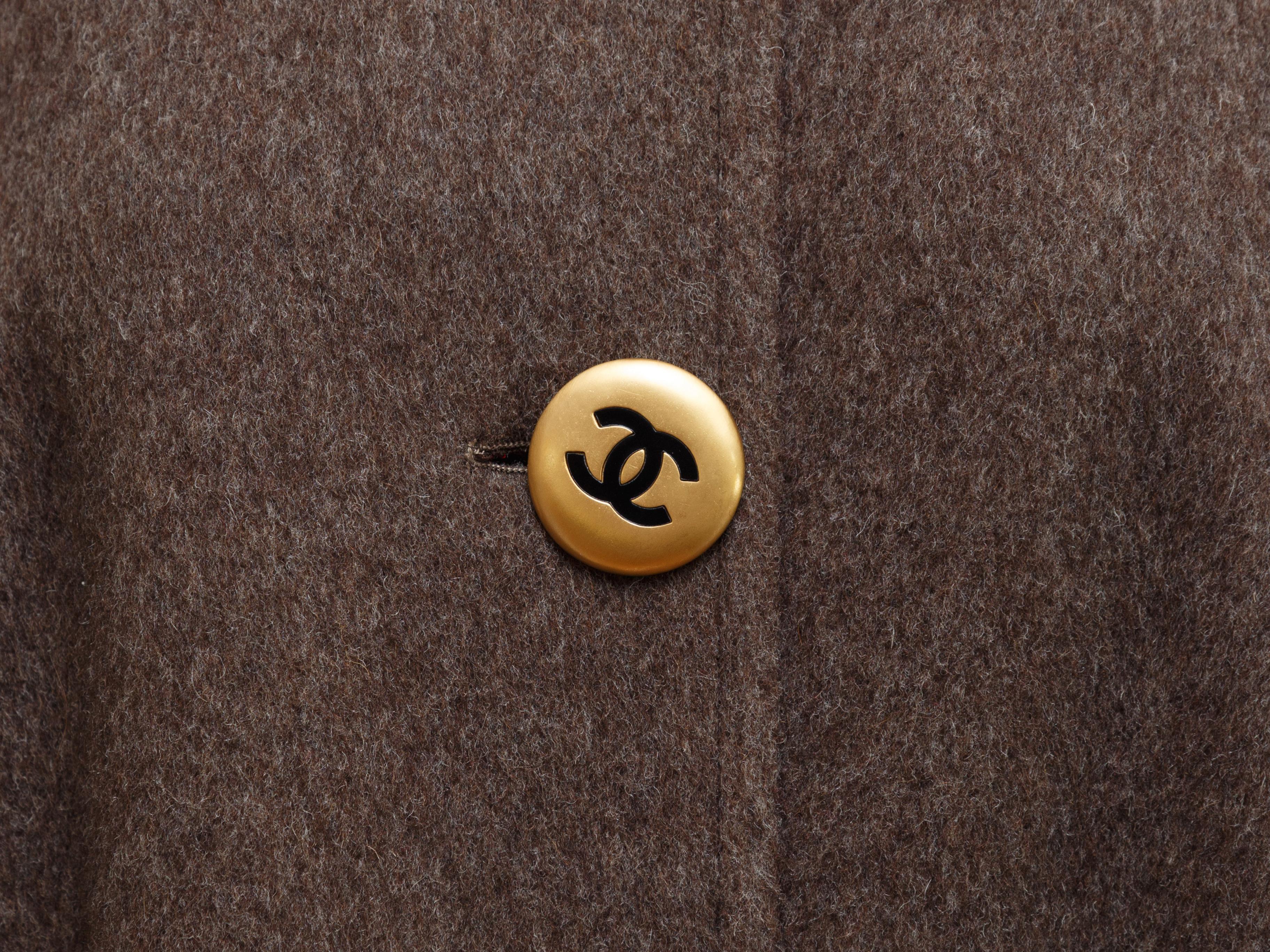 Product details: Brown Chanel Wool Coat. This raglan sleeve Chanel coat is lined in bright red wool, has gold tone buttons engraved with the designer's interlocking C's, and the coat is cut in an A-line. 29