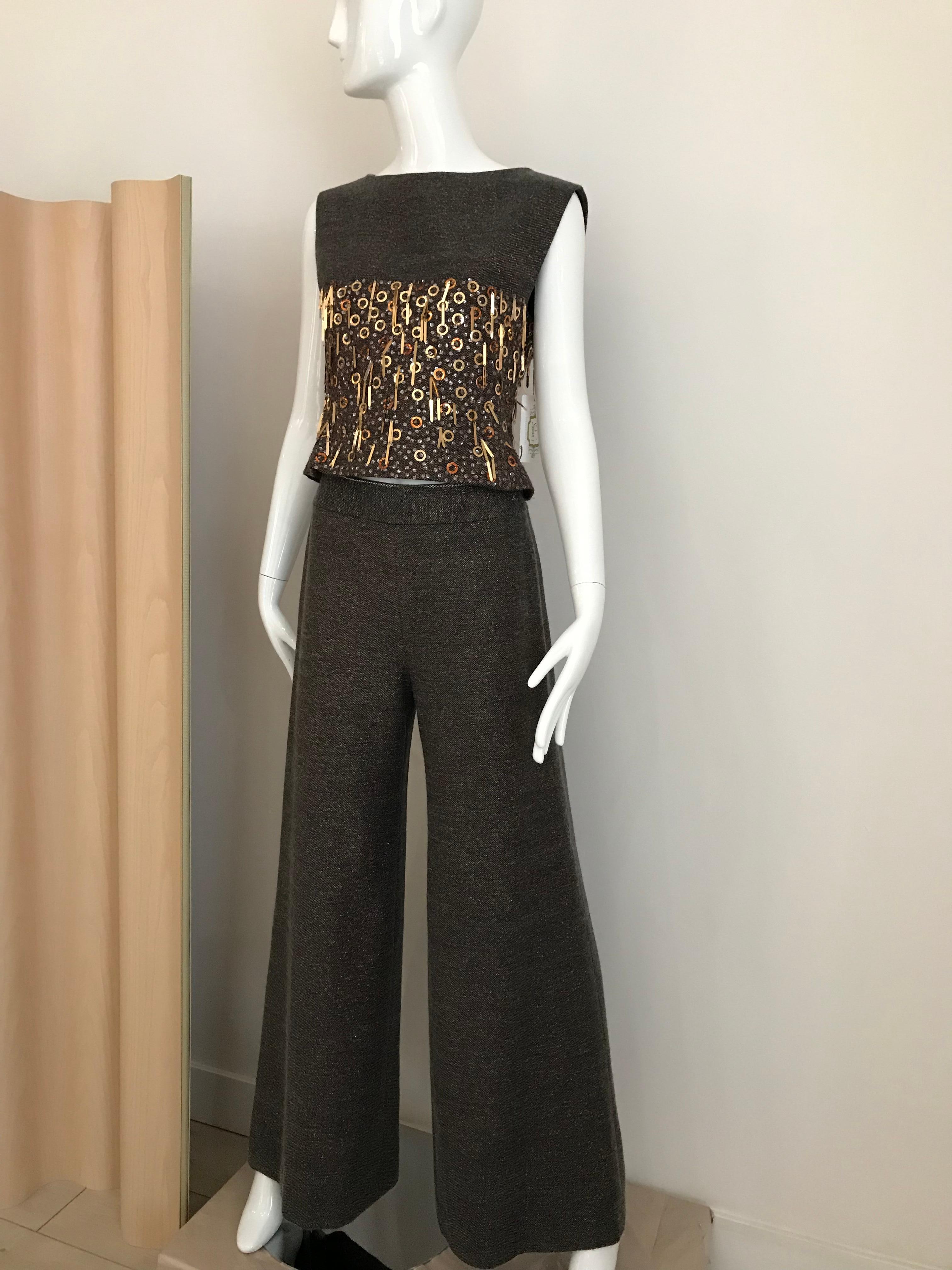 2000 Chanel  brown wool lined in silk with gold and bronze Pailletes.
Top measurement: Bust: 32 inches/  waist: 28 inches
Pant waist: 26 inches/ Hip: 38 inches/ Pants length: 43.5 inches
Fit size Small / 2-4 