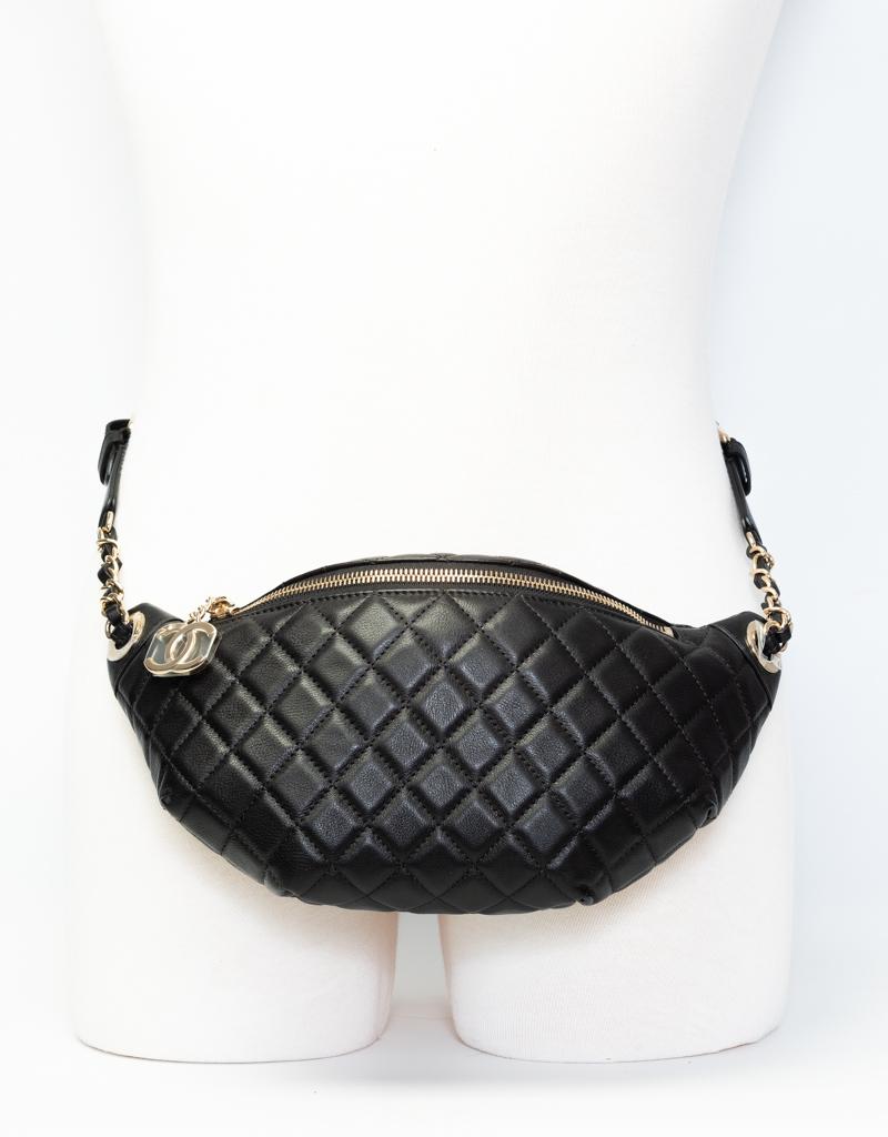 Chanel Bum Black Quilted Waist Bag. Featuring gold toned hardware, a chain zipper pull closure, an interlocking CC logo pendant, an adjustable belt strap that connects to gold toned chain interlaced with leather, and the interior is lined in black