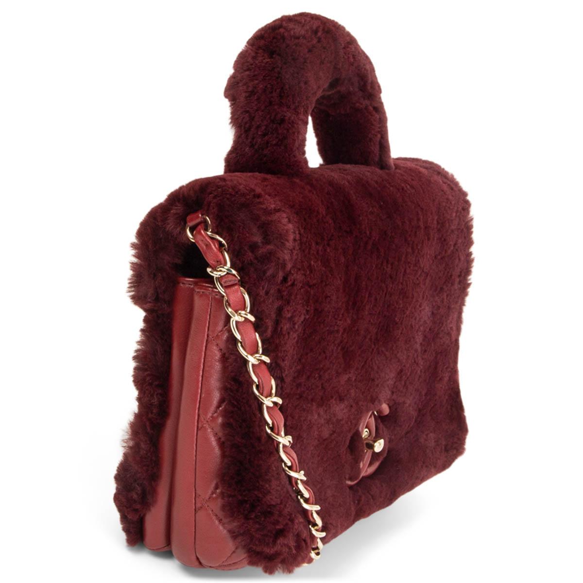 100% authentic Chanel 2017 Metiers d'Art top handle bag in burgundy orylag rabbit fur and quilted leather. Closes with a CC turn-lock on the front. Lined in leather featuring two compartments with a zipper pocket in the large section. Has been