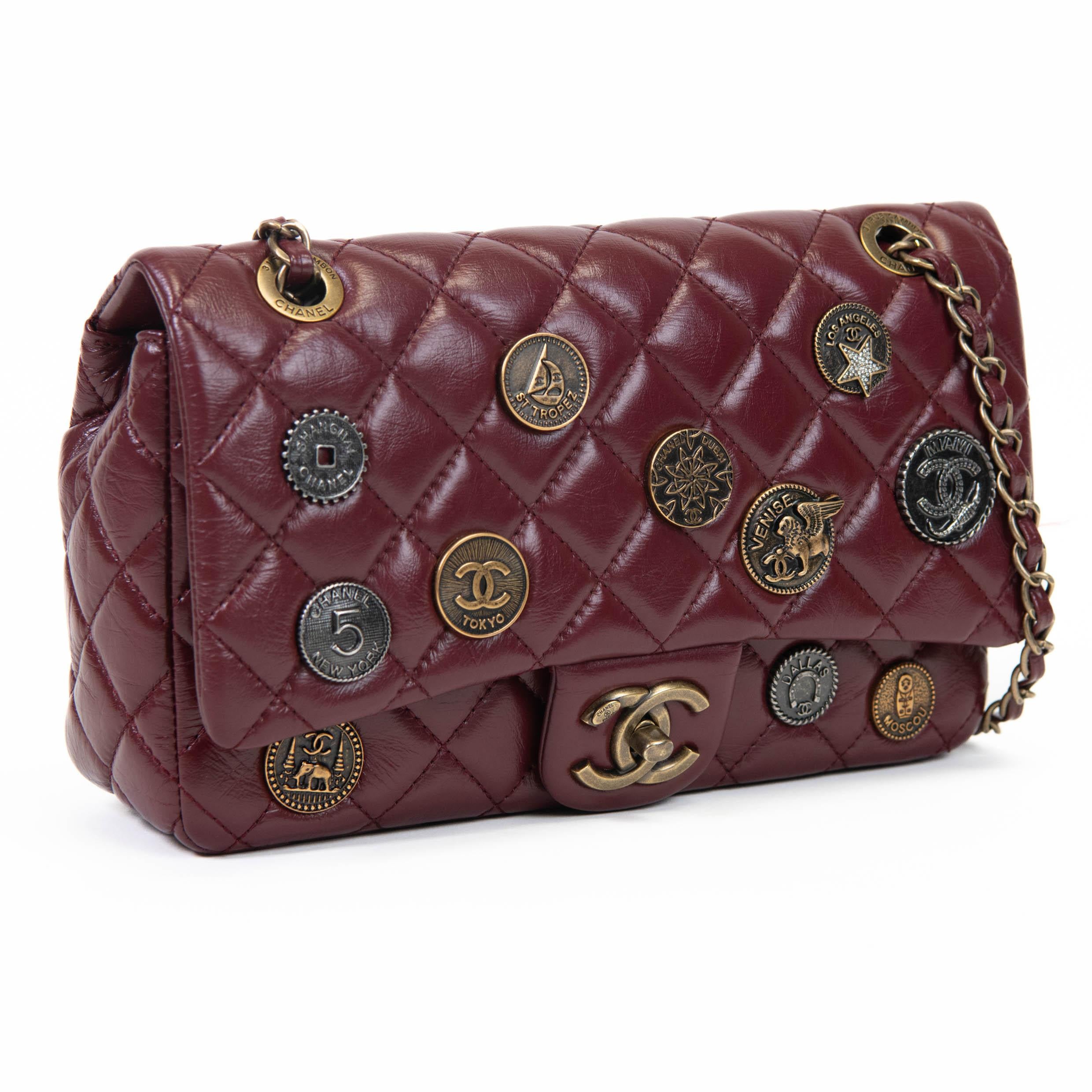 100% Authentic 

 This stylish classic flap shoulder bag is finely crafted of burgundy diamond quilted aged calfskin leather adorned with metal Chanel charms. The bag features a leather threaded an aged gold chain and an aged gold mademoiselle lock.