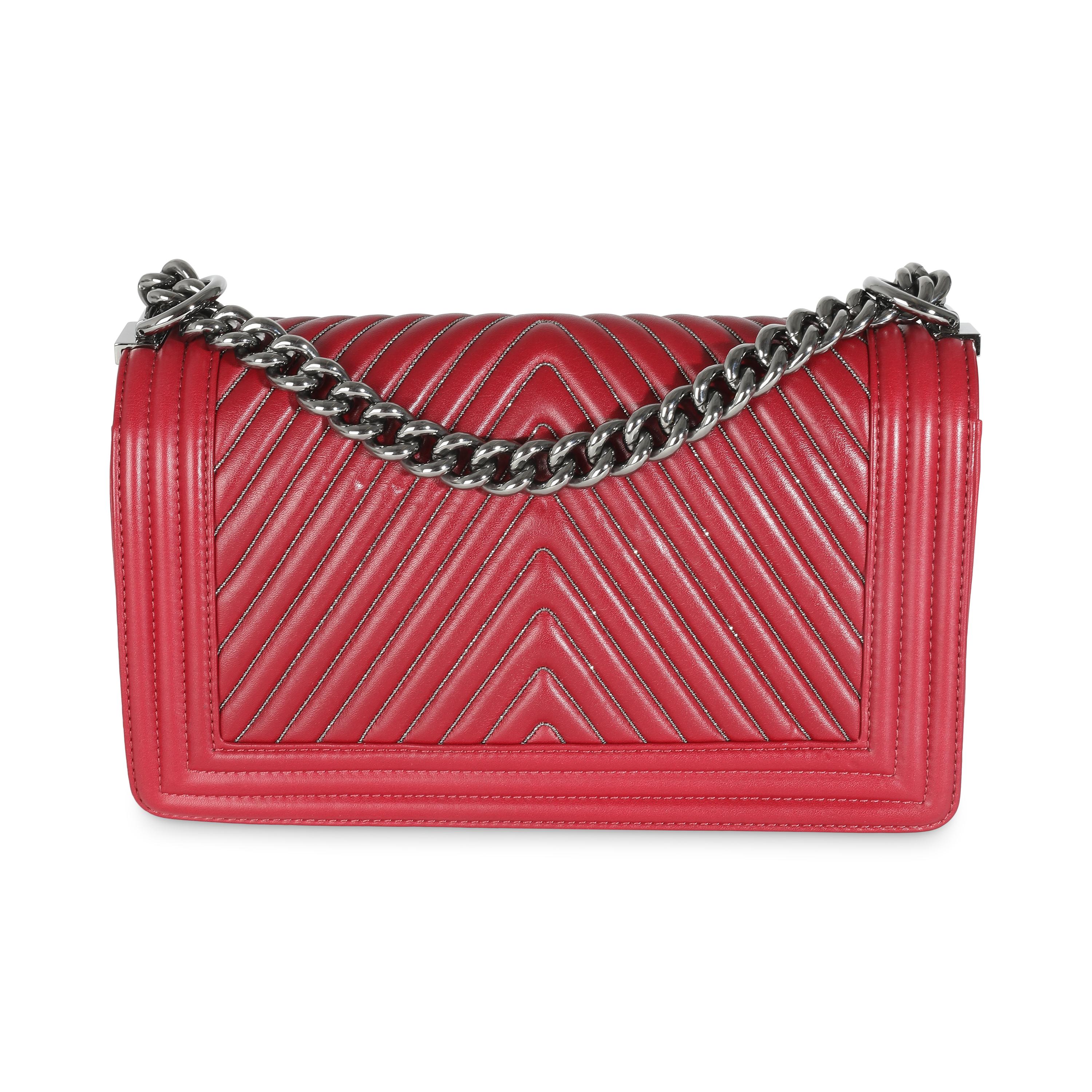 Listing Title: Chanel Burgundy Chevron Calfskin Chain Medium Boy Bag
SKU: 141493
Condition: Pre-owned 
Condition Description: An instant classic, the Boy bag from Chanel was introduced in 2011. The quilted bag was designed by the late Karl
