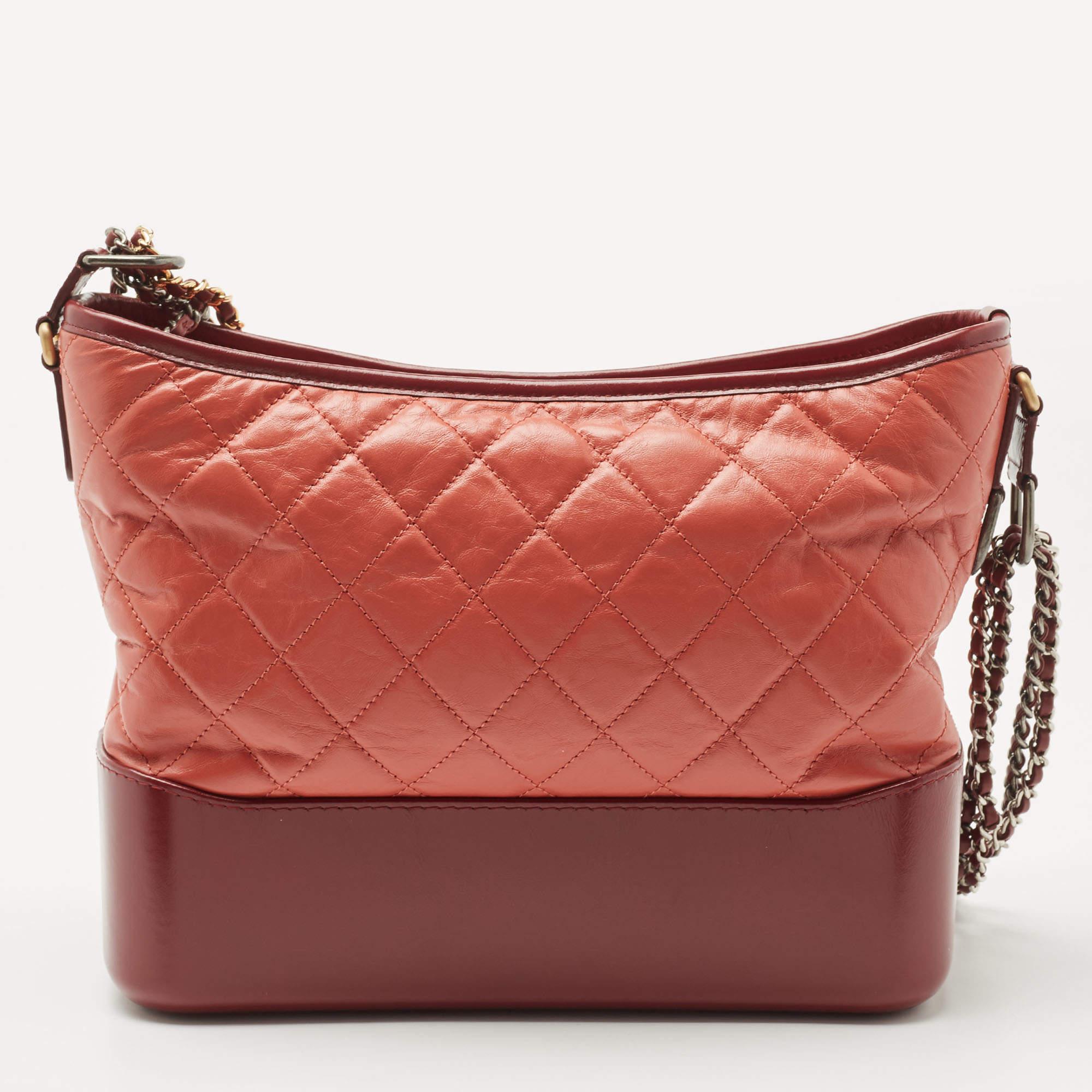 Get yourself this beautiful Gabrielle bag from the iconic house of Chanel. It exudes style and will always deliver sophistication. Crafted in Italy and made from aged leather, it comes in lovely shades of burgundy & orange. The exterior flaunts the
