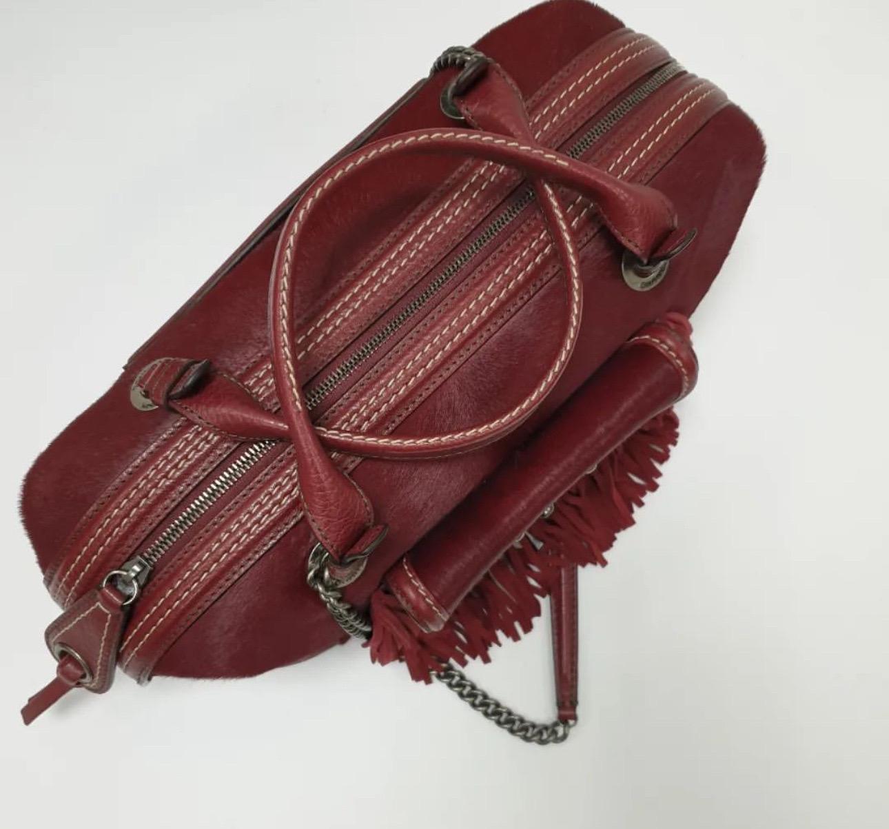 Chanel women's burgundy Pony hair and leather fringe Paris-Dallas bowling bag. Inspired by America and cowboys this fabulous bag from Chanel's 2014 Pre-Fall Meitiers D'Art, Paris-Dallas collection features incredible details such as pony hair with