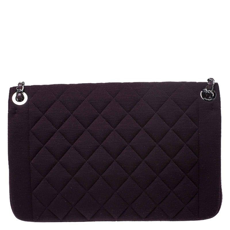 Chanel's Flap Bags are iconic and monumental in the history of fashion. This bag is a buy that is worth every bit of your splurge. Crafted from burgundy fabric, it bears their signature quilt pattern and the iconic CC on the flap. The piece has