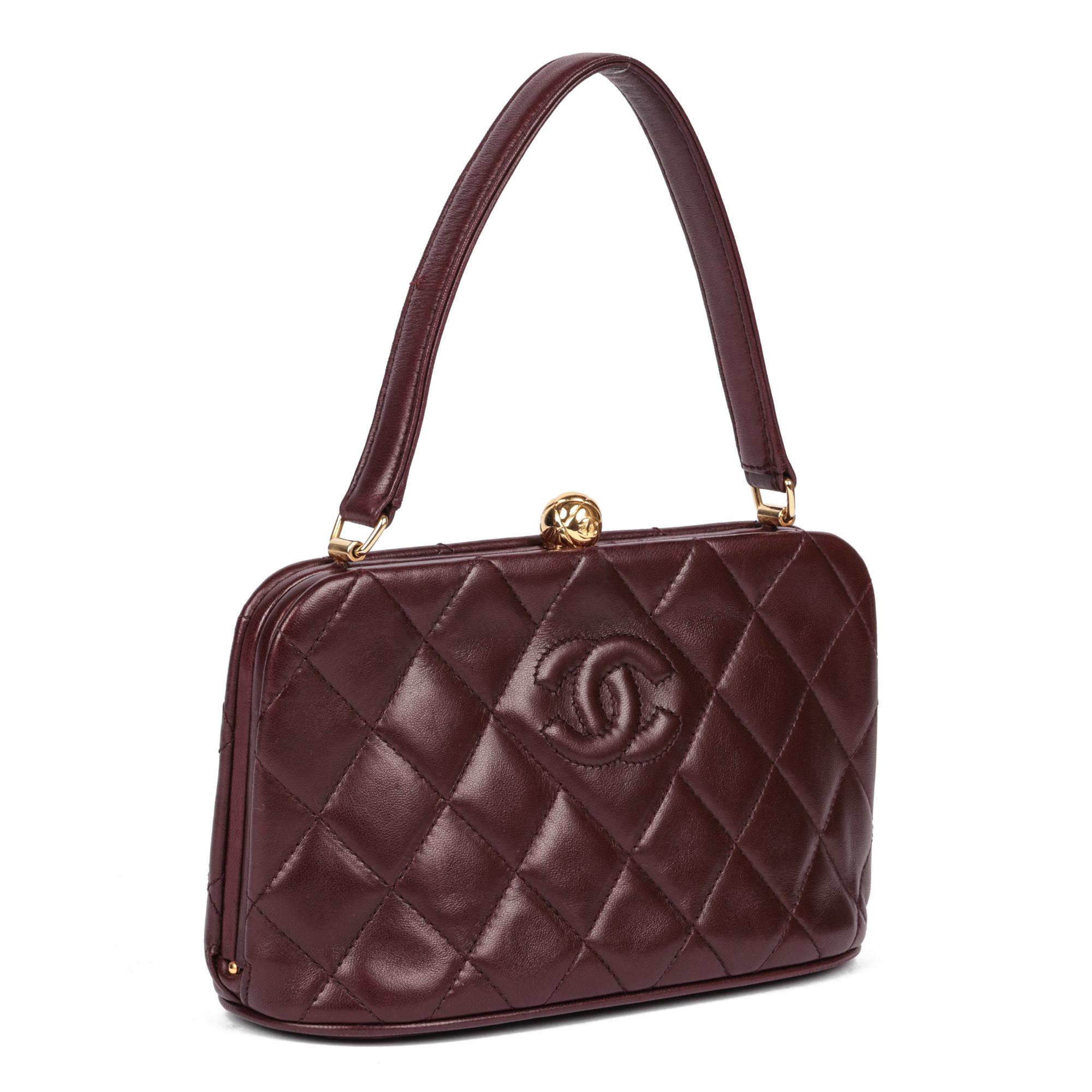 CHANEL
Burgundy Quilted Lambskin Timeless Top Handle Frame Bag

Serial Number: 3481690
Age (Circa): 1995
Accompanied By: Chanel Dust Bag
Authenticity Details: Serial Sticker (Made in Italy)
Gender: Ladies
Type: Top Handle 

Colour:
