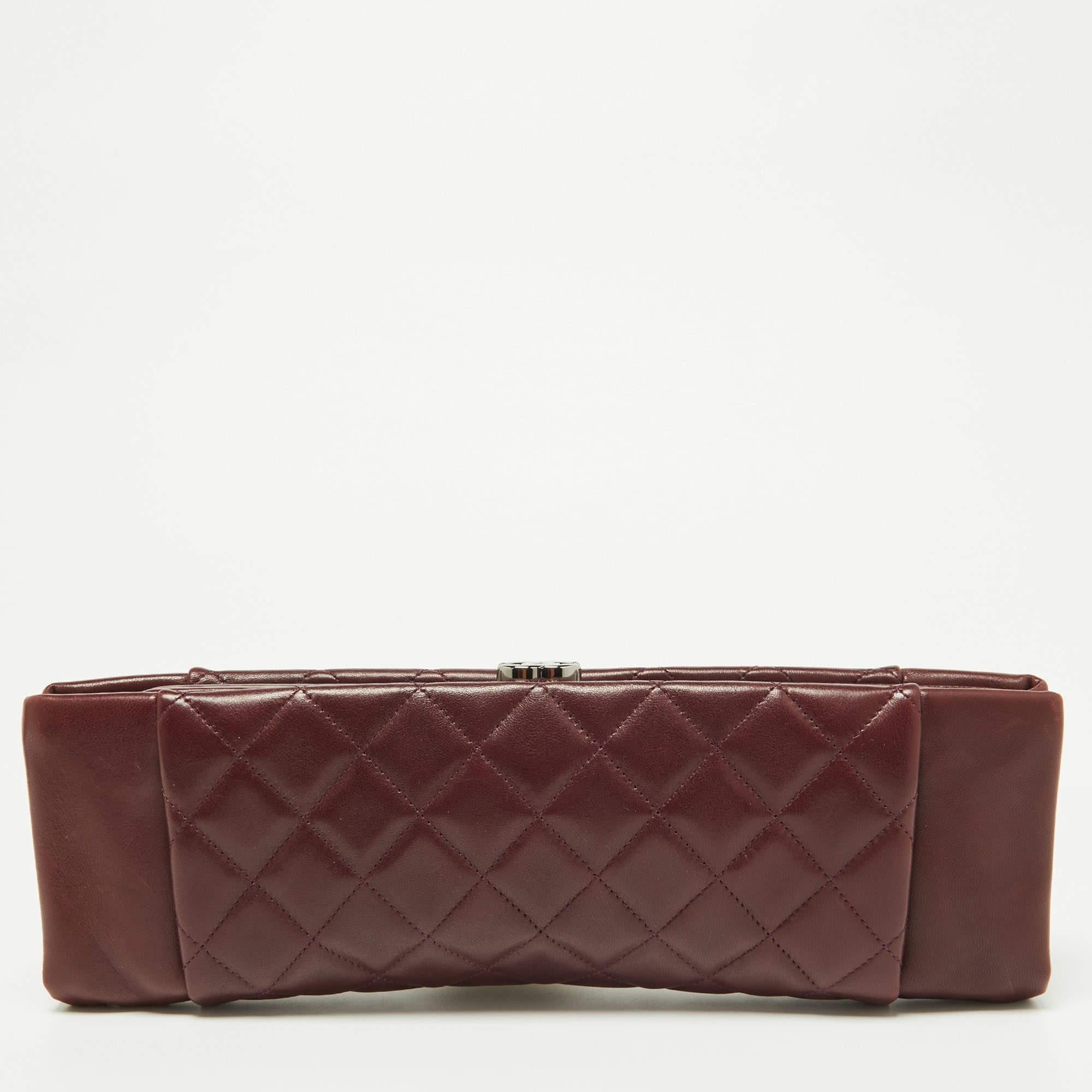 The Chanel clutch is a luxurious accessory crafted from rich, deep burgundy leather. Its quilted pattern exudes elegance, while the iconic CC logo adds a touch of sophistication. This spacious clutch is perfect for evening events, with a timeless
