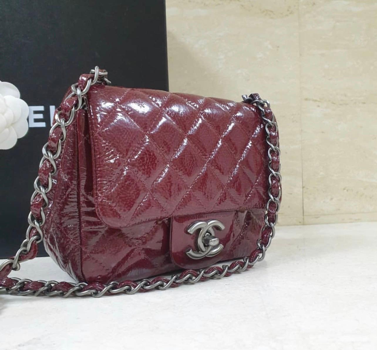 Chanel Quilted Patent Leather Classic Mini Flap Bag. 
It is the perfect small size that amazingly holds your cell phone, keys, and lip gloss.
 It also features an inside flat pocket that fits cards or money as well as one zip pocket for items that