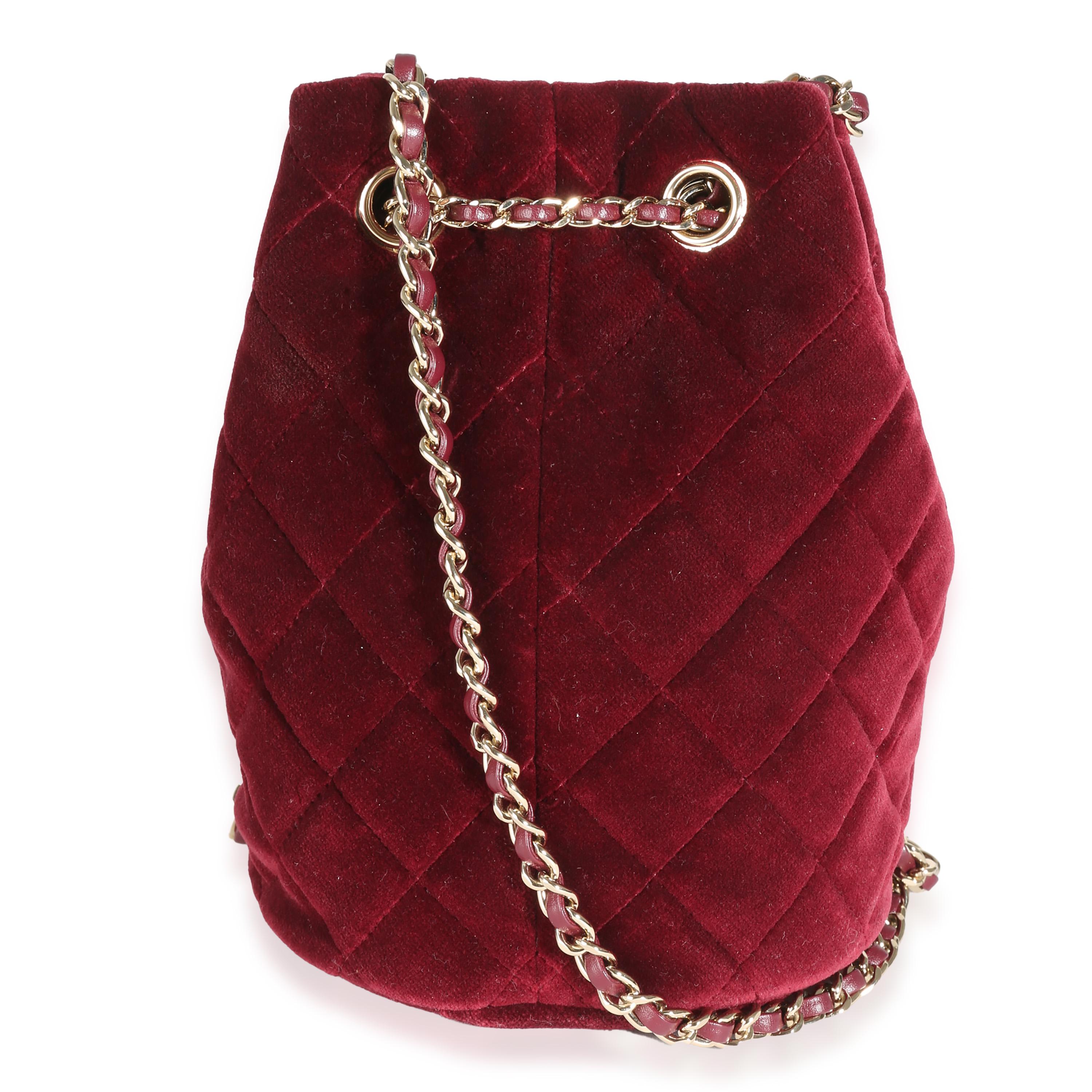 Listing Title: Chanel Burgundy Quilted Velvet CC Pearl Crush Bucket Bag
SKU: 142015
Condition: Pre-owned 
Handbag Condition: Very Good
Condition Comments: Item is in very good condition with minor signs of wear. Light scratching along