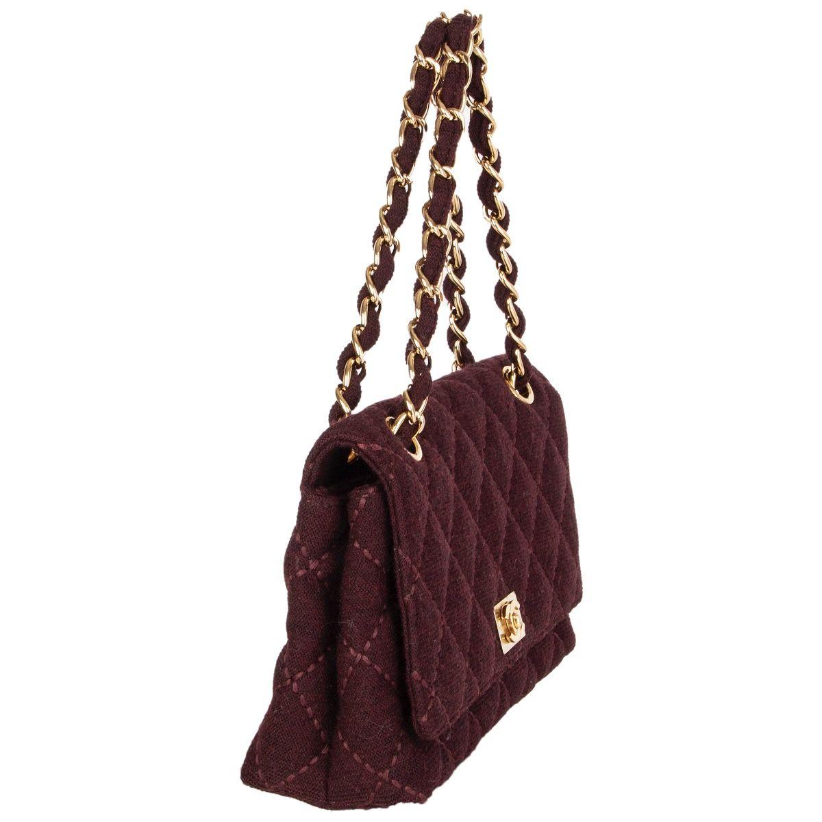 100% authentic Chanel vintage shoulder bag in burgundy wool jersey featuring light gold-tone chain strap and CC turn-lock. Lined in burgundy calfskin with a zipper pocket against the back and one open pocket against the front. Slip pocket on the