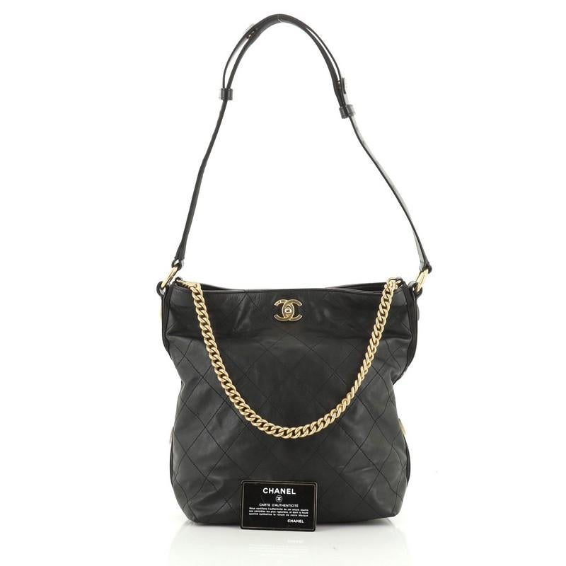 This Chanel Button Up Hobo Quilted Calfskin with Grosgrain Large, crafted from black quilted calfskin with grosgrain, features chain link handle, flat shoulder strap, and gold-tone hardware. Its CC turn-lock closure opens to a red fabric interior