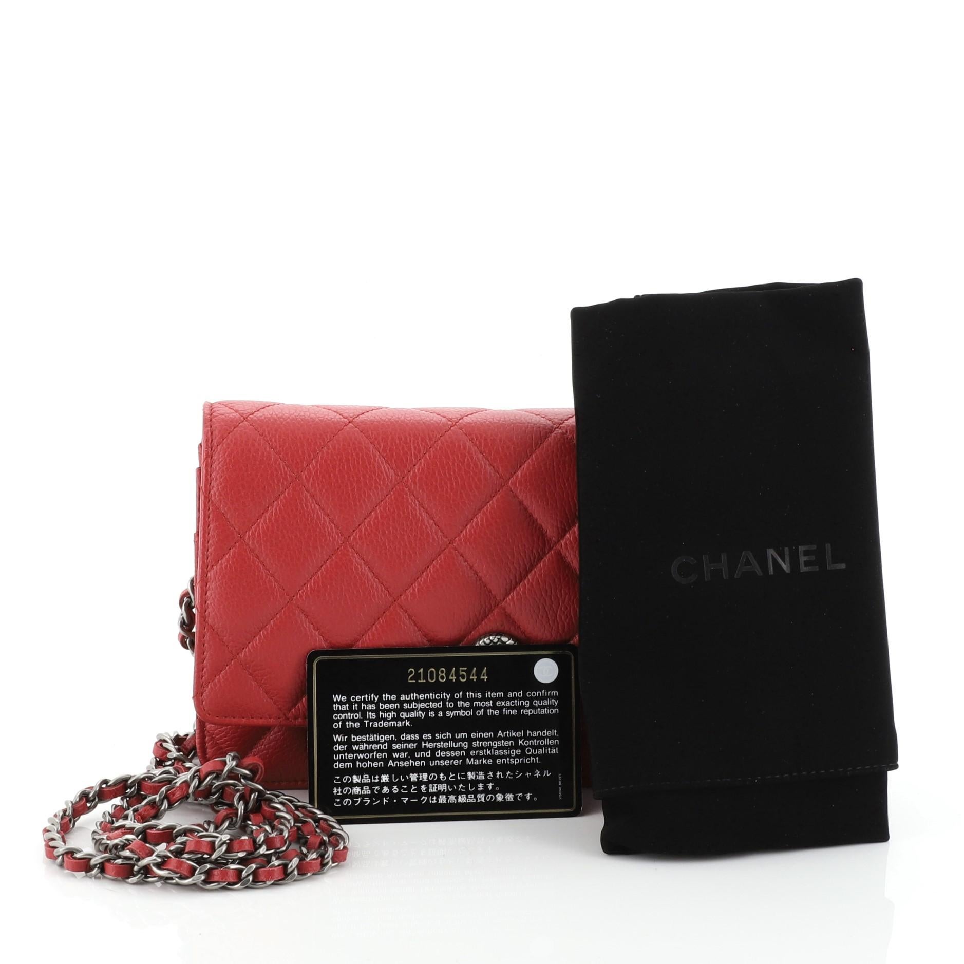 This Chanel Button Wallet on Chain Quilted Goatskin, crafted from red quilted goatskin, features CC logo at the front and aged silver-tone hardware. Its snap closure opens to a red leather interior with zip and slip pockets. Hologram sticker reads: