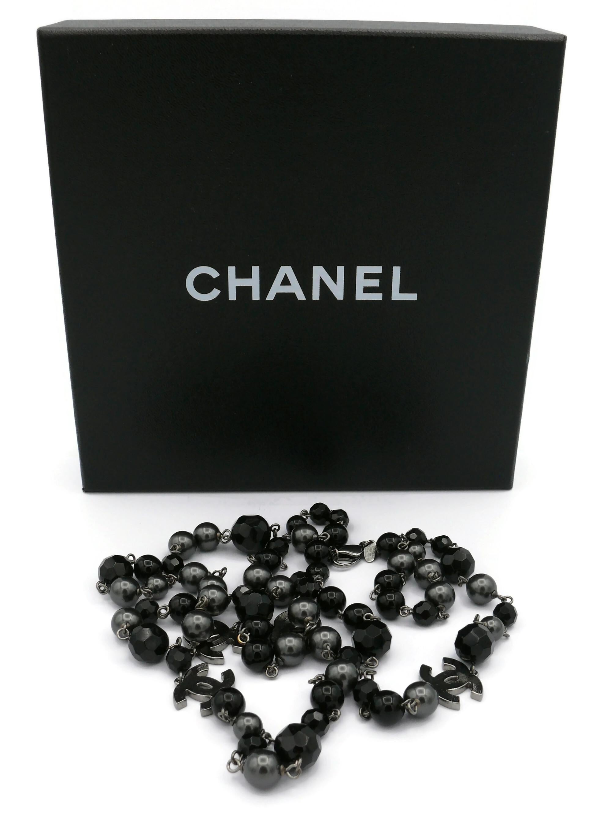 CHANEL by KARL LAGERFELD necklace featuring a strand of black beads and grey faux pearls with four silver tone textured CHANEL CC logos.

This necklace can be wrapped two times around the neck.

Lobster clasp closure.

Embossed CHANEL 10 V  Made