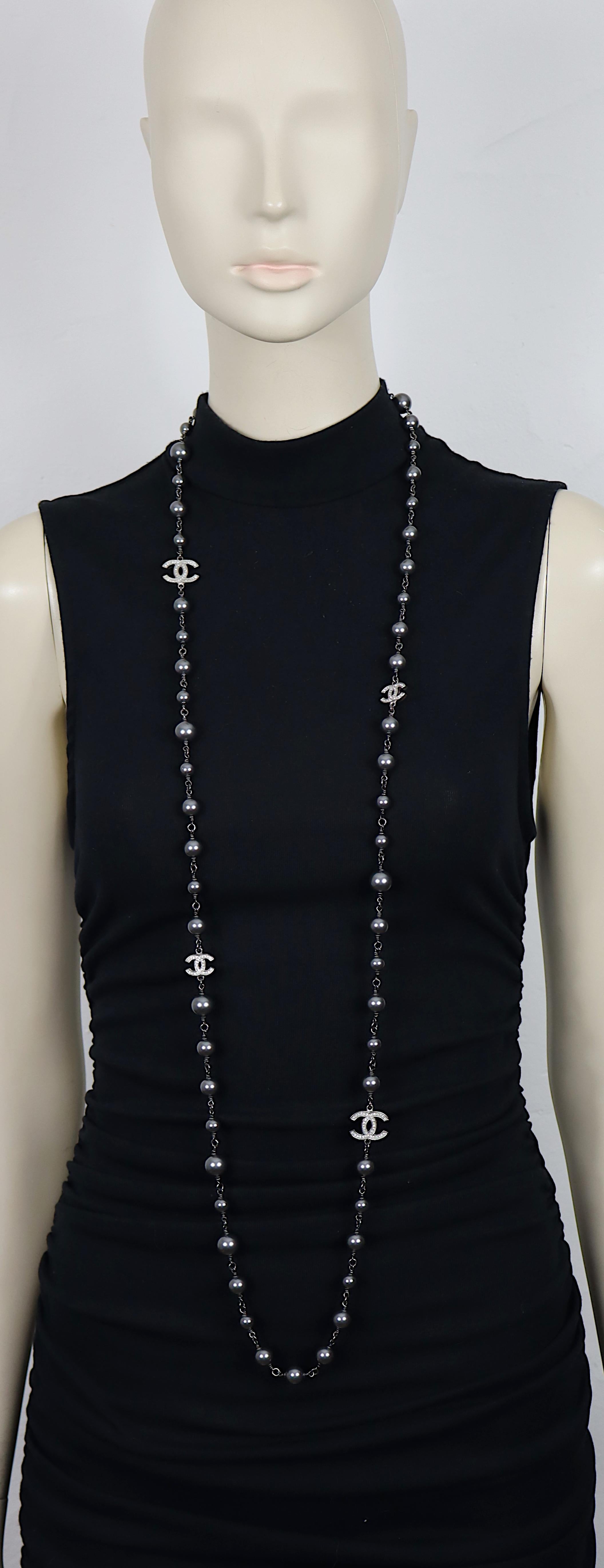 CHANEL by KARL LAGERFELD ruthenium tone necklace featuring a strand of grey faux pearls with four silver tone CHANEL CC logos embellished with clear crystals.

Can be wrapped two times around the neck.

Lobster clasp closure.

Laser mark CHANEL B14