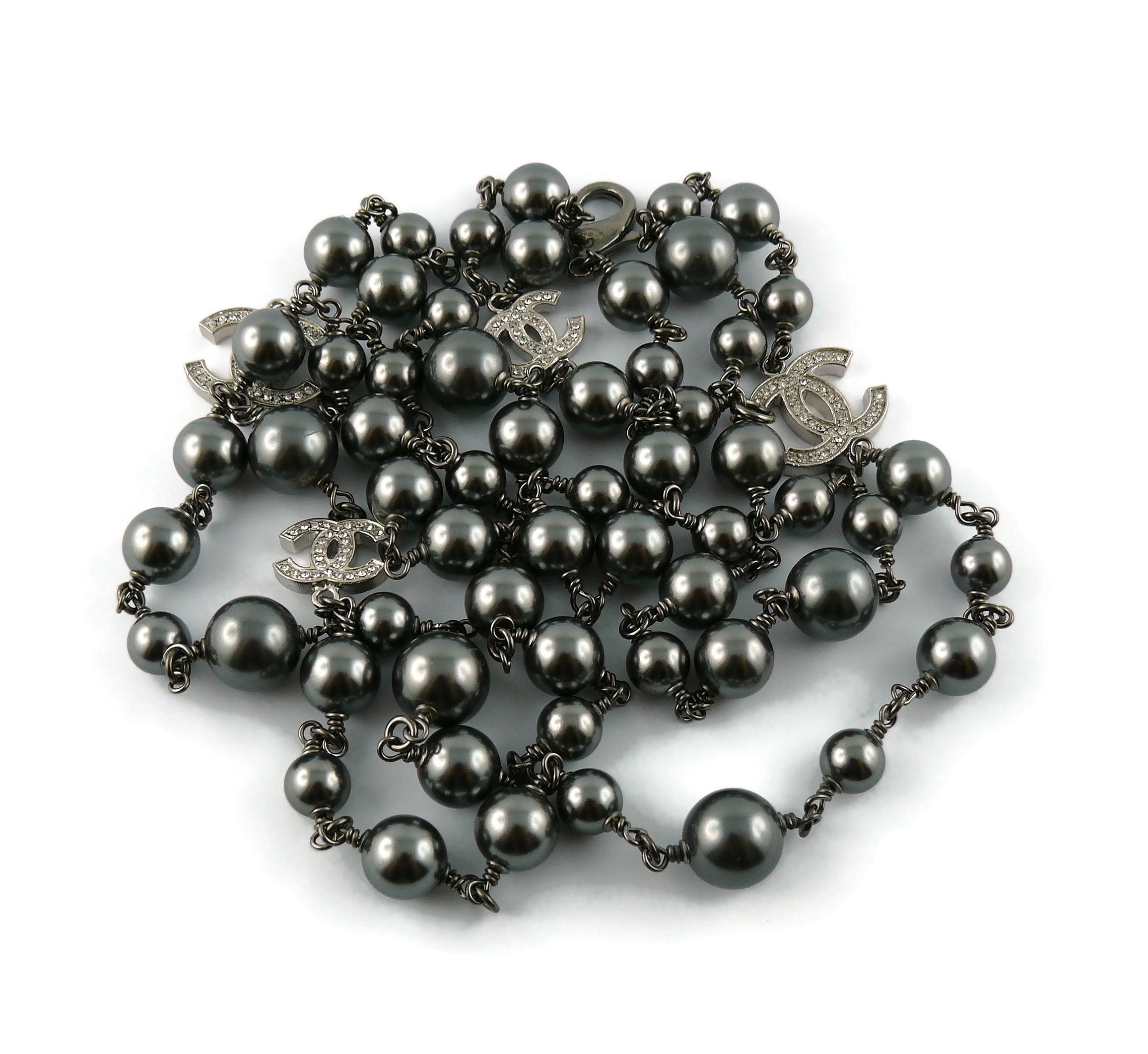 CHANEL necklace featuring a strand of hematite grey color faux pearls with four silver toned graduated CHANEL CC logos embellished with clear crystals. 

Ruthenium hardware.

This necklace can be wrapped three times around the neck.

Lobster clasp
