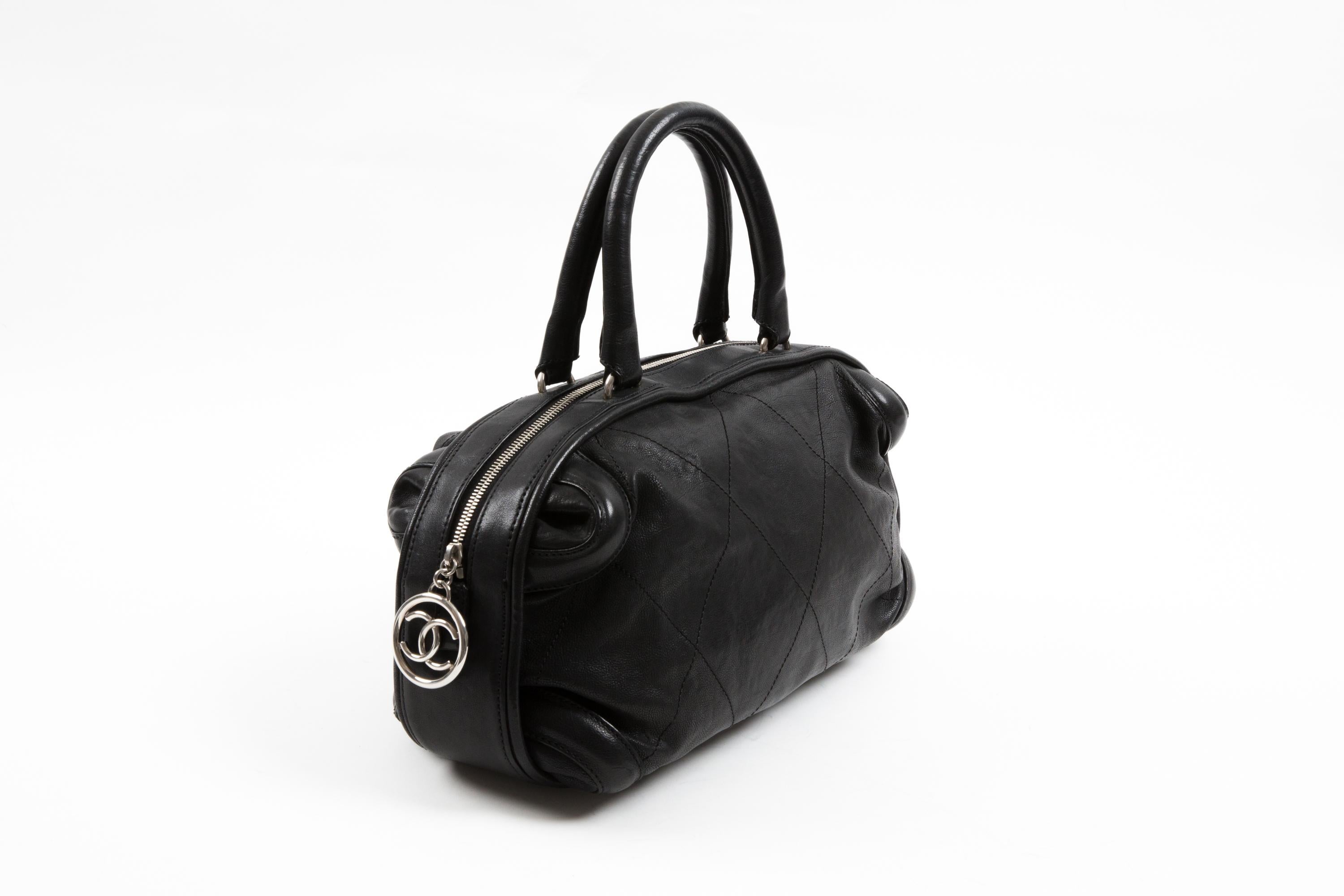 Chanel by Karl Lagerfeld Black grained calfskin wild stitched leather “Boston” bag featuring silver tone hardware with top zipper closure, tonal canvas lining with inner zipper and slip pockets. 
Circa 2005-2006.
In good vintage condition. Made in
