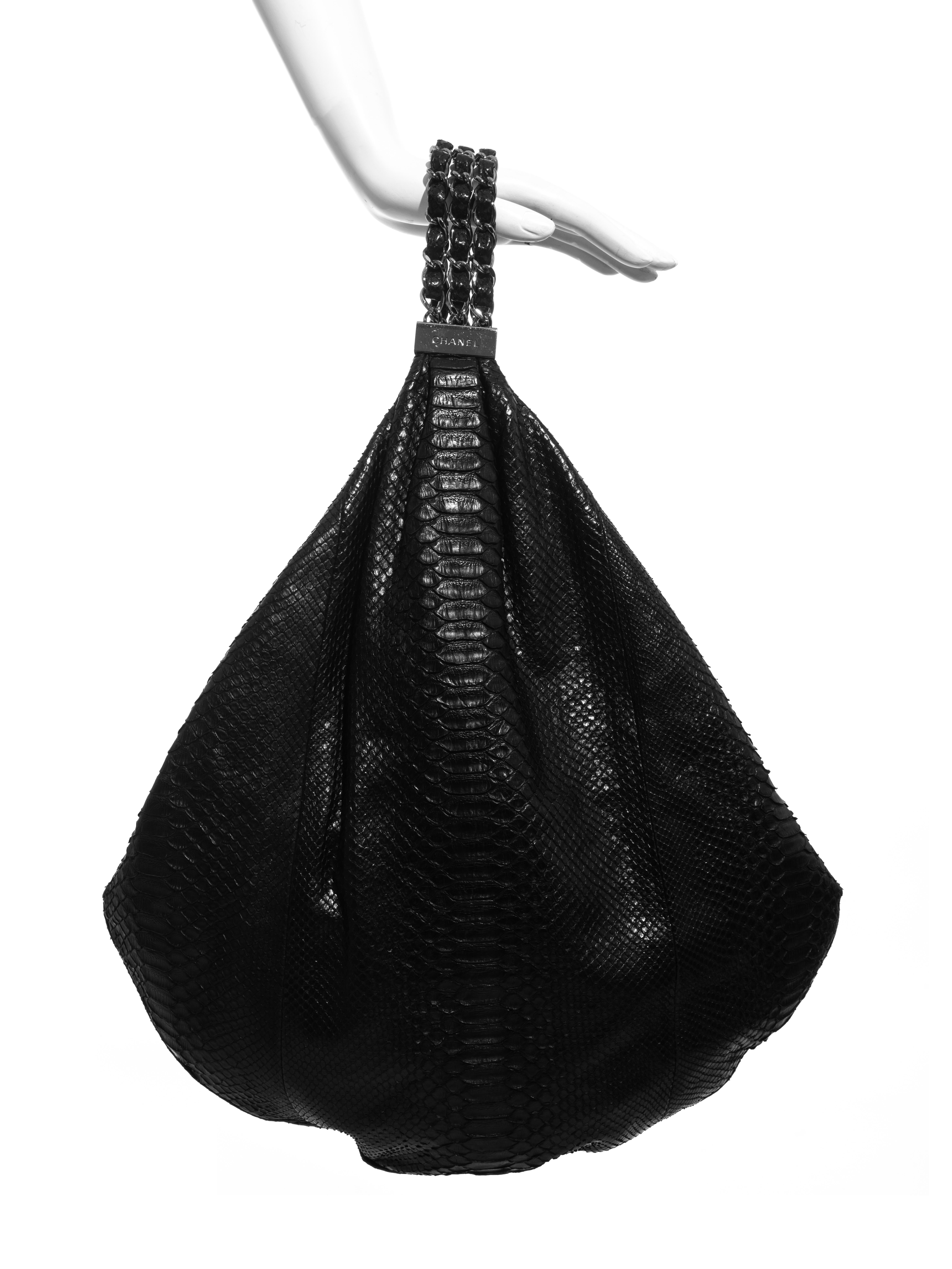 Chanel by Karl Lagerfeld black python hobo bag with three stand chain handle, 'cc' keychain, zip closure and grey satin lining. Sold with original dust bag. 

Spring-Summer 2007
