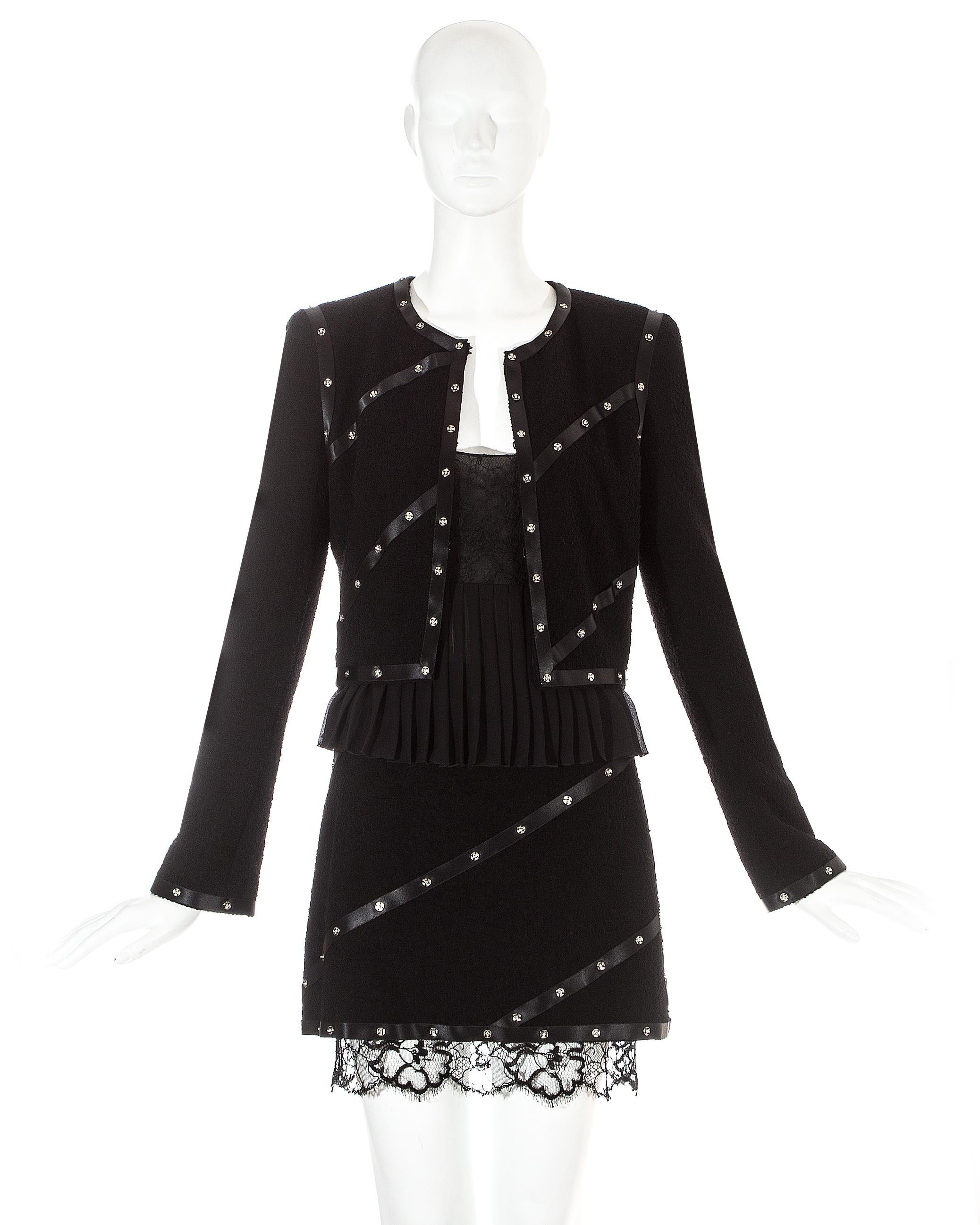 Chanel by Karl Lagerfeld, 3 piece skirt suit. Long sleeve fitted jacket with silk ribbon bands and metal press studs. Matching mini skirt with lace hem. Silk chiffon pleated cropped vest with lace bra.

Fall-Winter 2003
