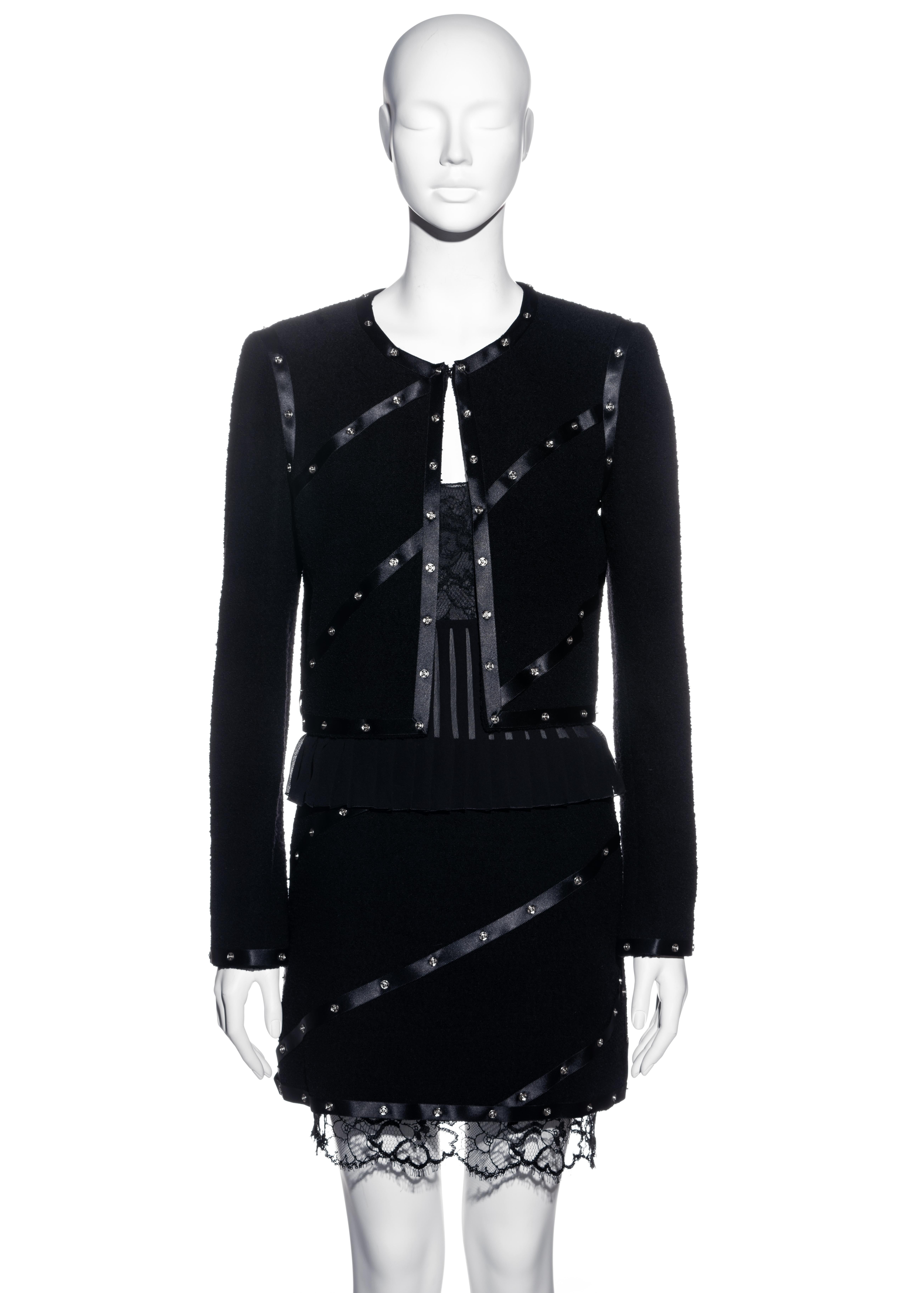 ▪ Chanel black boucle wool skirt suit 
▪ Designed by Karl Lagerfeld
▪ 100% Wool, 100% Silk 
▪ Silk ribbon with silver press studs 
▪ Fitted jacket 
▪ Mini skirt with lace underskirt 
▪ Lace vest with pleated silk chiffon 
▪ FR 40 - UK 12 - US 8 
▪