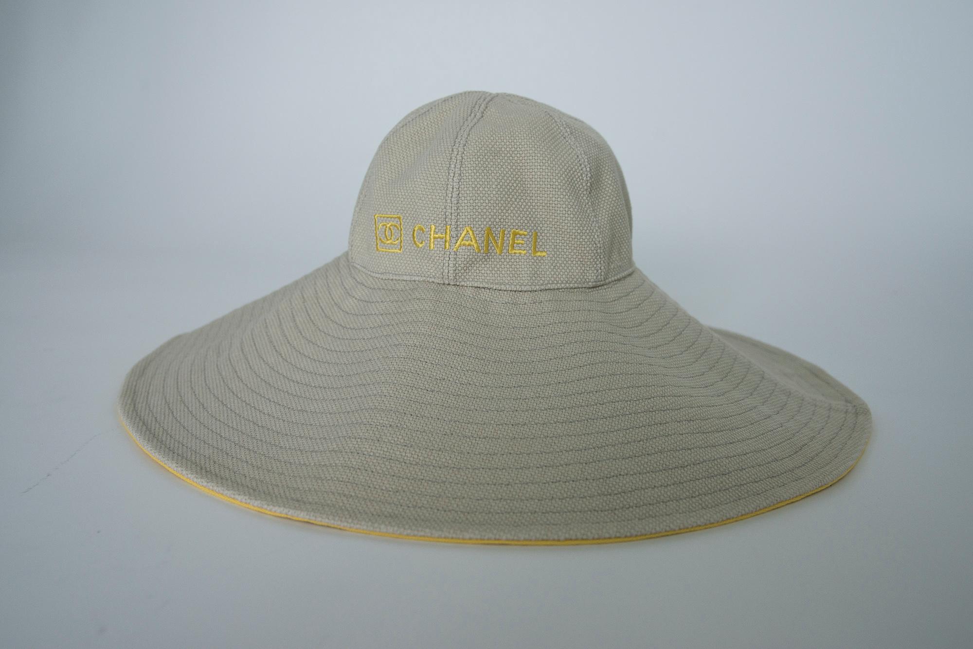 From an early 2000's Chanel by Karl Lagerfeld collection, this rare sunhat is made from beige cotton-canvas (composition tag is missing though) and embroidered with the signature CC logo and the label's logo lettering across the front. Designed on