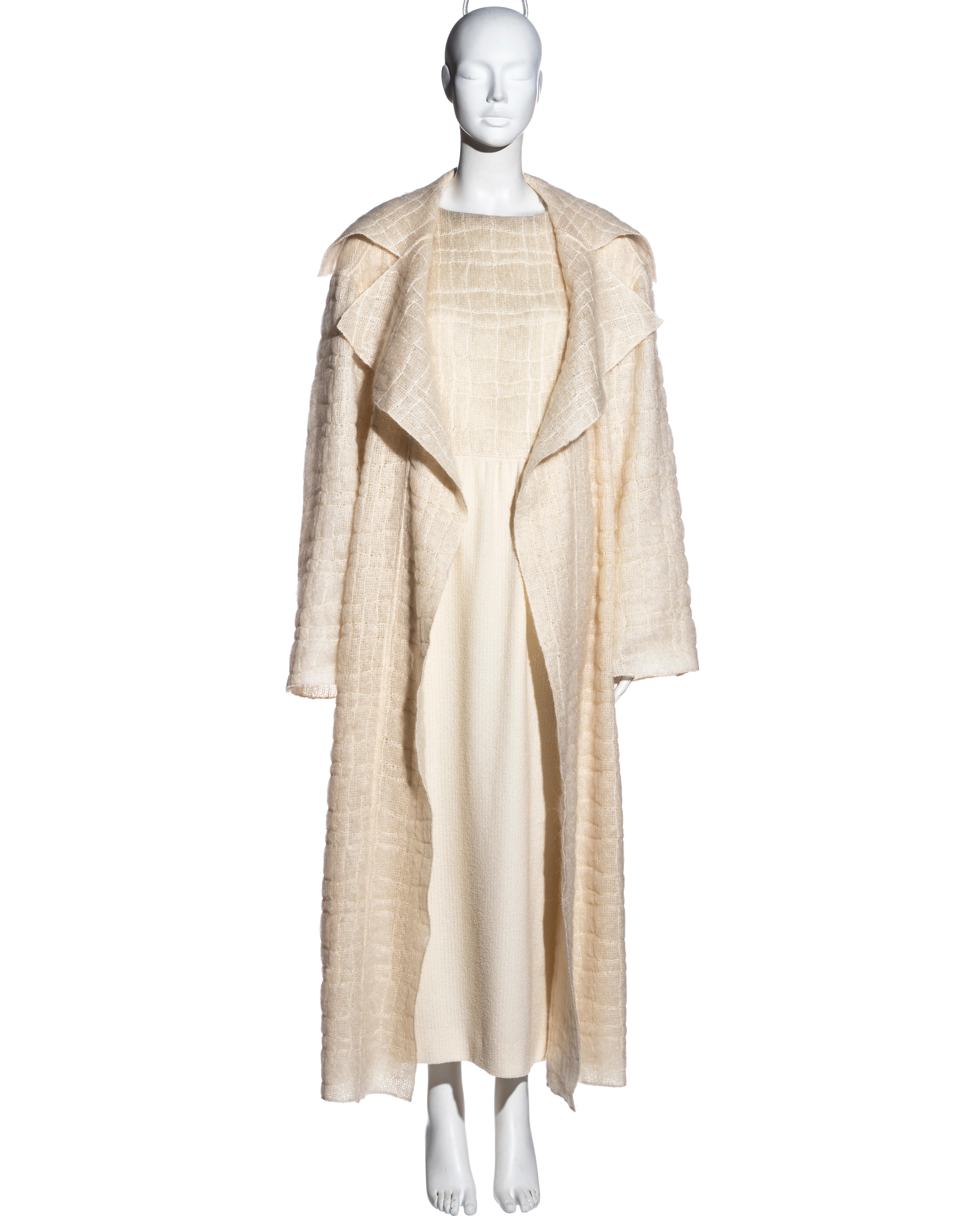 ▪ Chanel cream mohair wool coat and dress ensemble 
▪ Designed by Karl Lagerfeld 
▪ Oversized open-front coat with matching belt 
▪ Large notched lapels 
▪ Built-in shoulder pads 
▪ Matching dress with ankle-length skirt 
▪ Logo button fastenings at