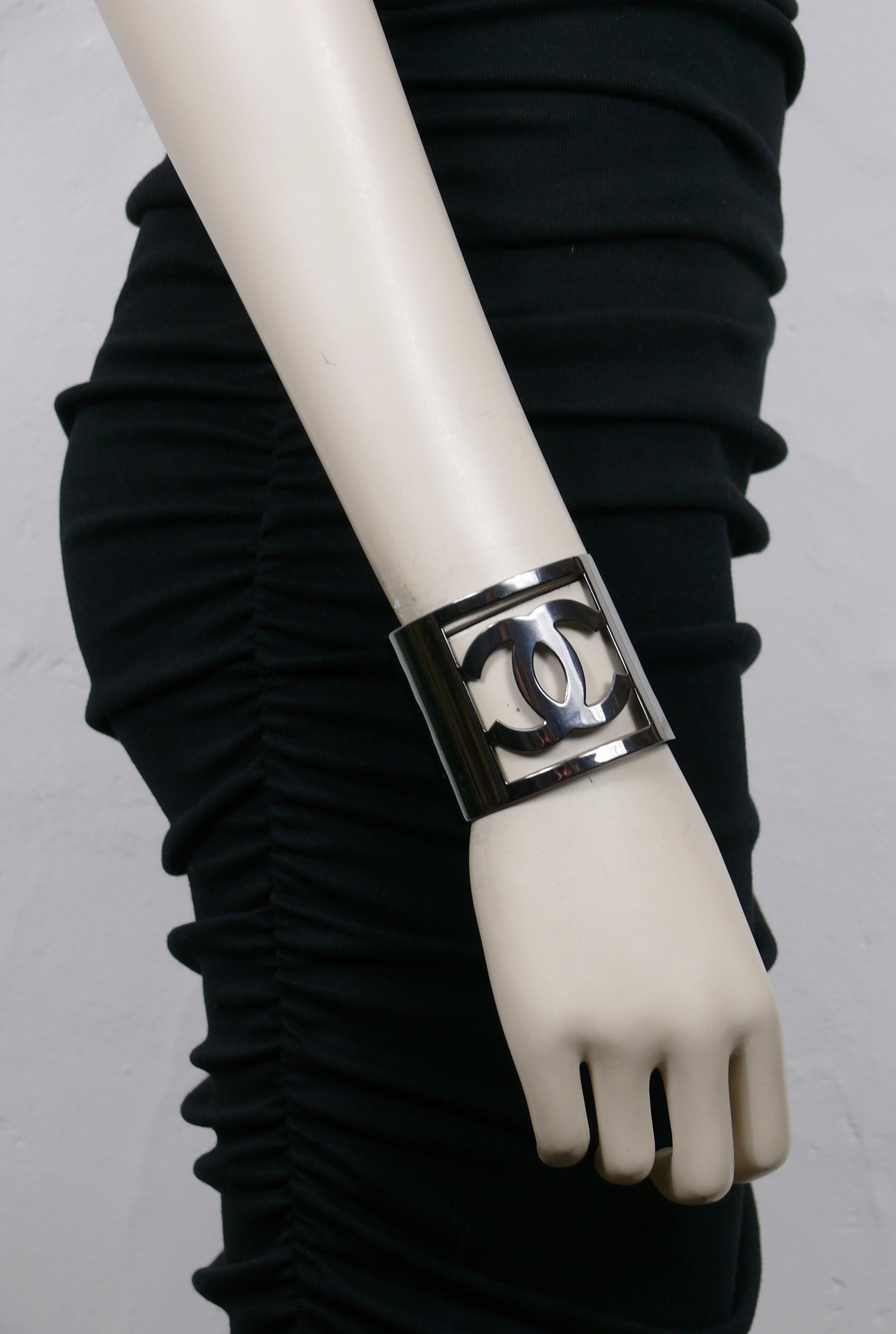 CHANEL by KARL LAGERFELD polished ruthenium tone cuff bracelet featuring a large cut-out CC logo at the center.

From the Autumn/Winter 2006 Collection.

Embossed CHANEL 06 A Made in France.

Indicative measurements : inner circumference approx.