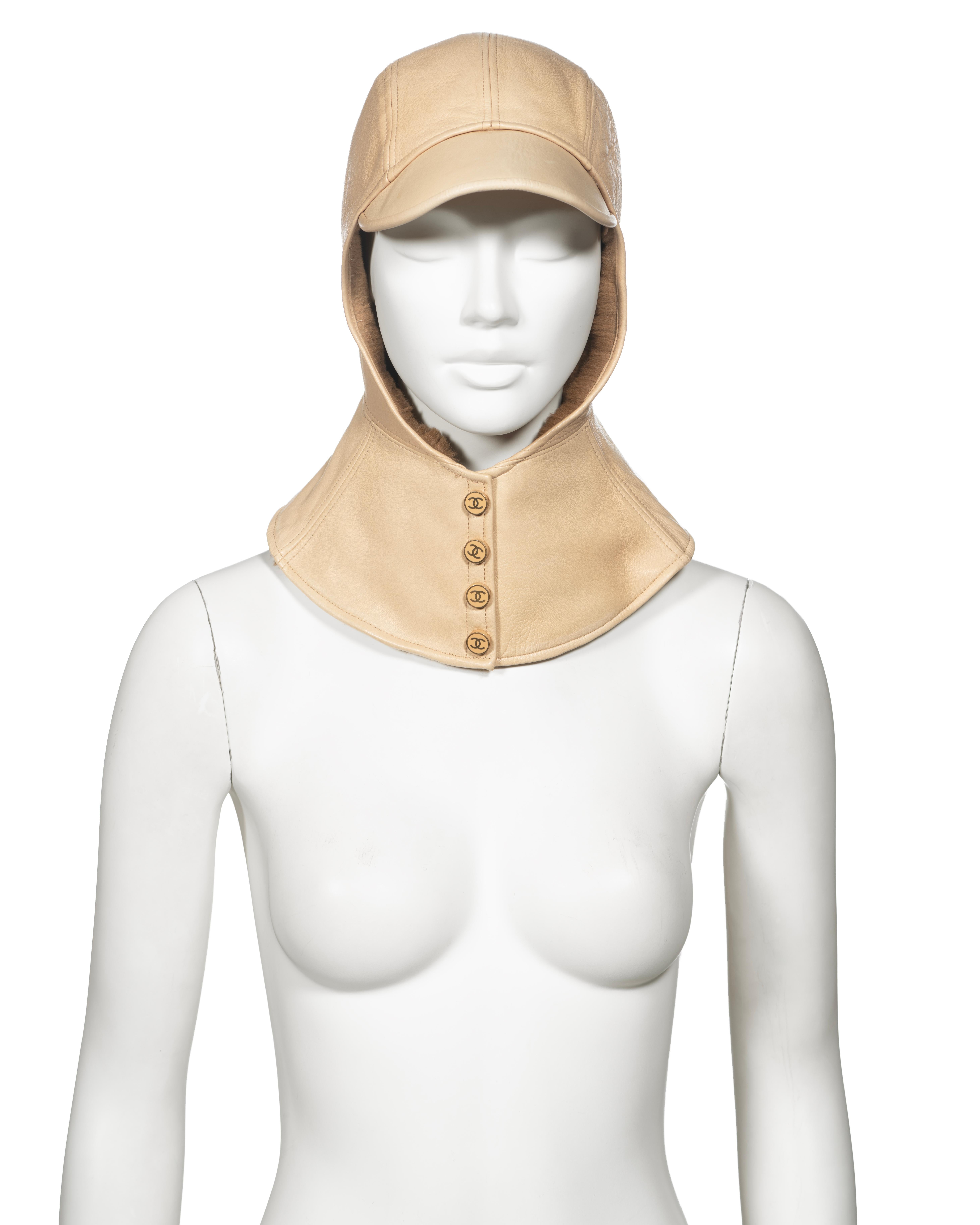▪ Archival Chanel Lambskin Leather Hat
▪ Creative Director: Karl Lagerfeld
▪ Fall-Winter 2001
▪ Crafted from luxurious cream lambskin leather
▪ Lined with sheared rabbit fur for added warmth and comfort
▪ Features a built-in neck flap that covers