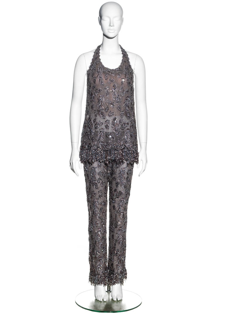 ▪ Chanel Haute Couture mauve lace evening pant suit 
▪ Designed by Karl Lagerfeld 
▪ Embroidery by Lesage in a plethora of beads, sequins and crystals 
▪ Sequin tassel trim
▪ Built-in corset 
▪ Halter neck 
▪ Silk chiffon lining 
▪ Approx. FR 40 -