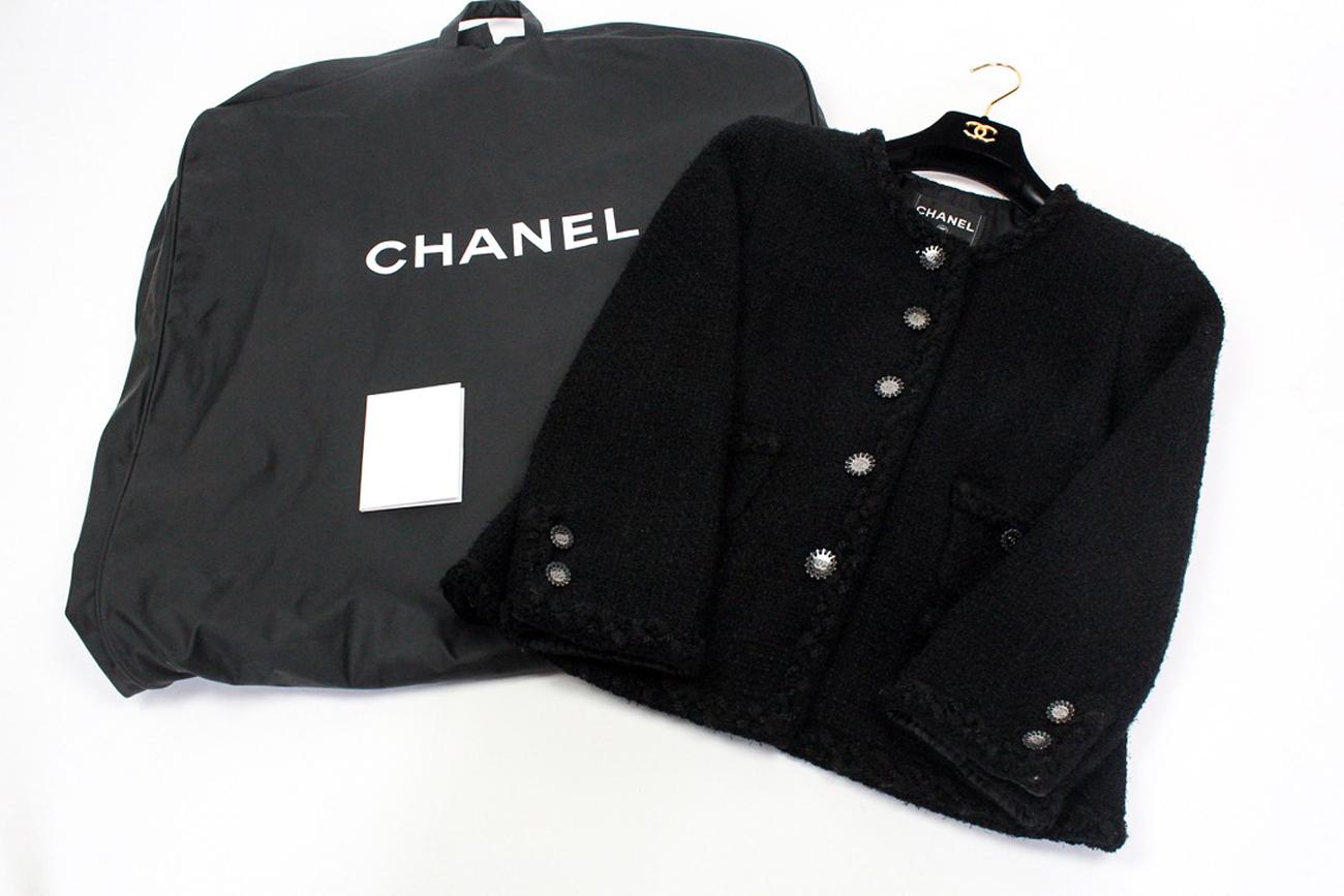 Chanel La Petite Veste Noire, incredible collector's little black jacket, designed by Karl Lagerfeld for the Cruise 2011 collection. This design featured in the 2011 Chanel exhibition dedicated to the little black jacket. An identical jacket was