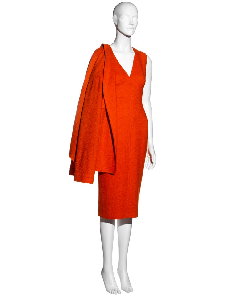 ▪ Chanel orange bouclé wool dress and jacket set 
▪ Designed by Karl Lagerfeld 
▪ Mid-length sheath dress with v-neck  
▪ Back vent with gold 'CC' buttons  
▪ Silk lining 
▪ Unlined loose-cut jacket with open front  
▪ Two front patch pockets  
▪