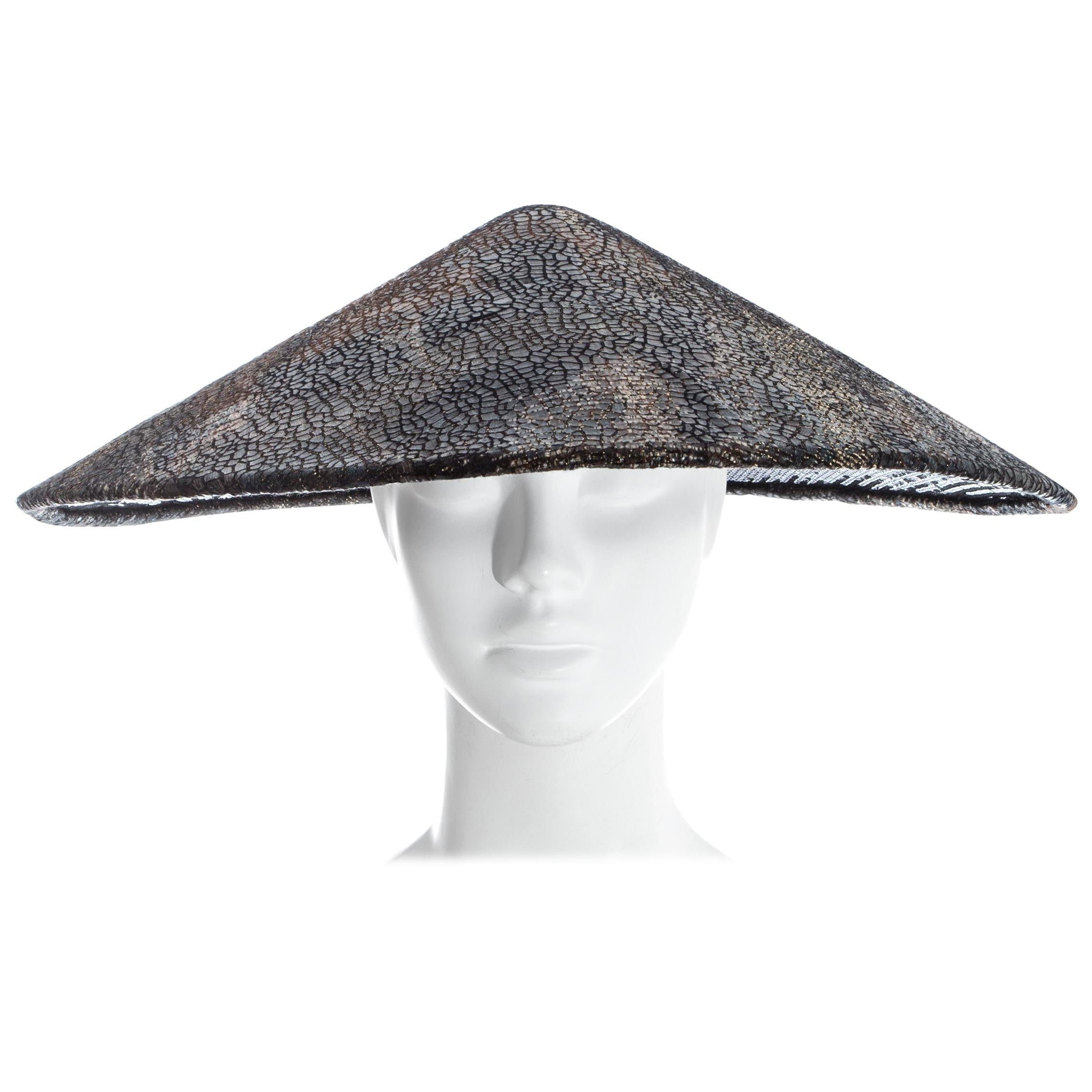 Chanel by Karl Lagerfeld, Bronze, gold and black tweed conical evening hat with textured overlay and black sequin lining. 

'Paris-Shangai' Pre-Fall 2010