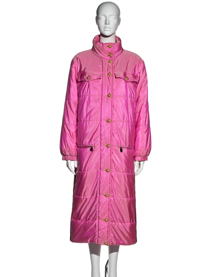 ▪ Chanel pink silk puffer coat 
▪ Designed by Karl Lagerfeld 
▪ Oversized fit 
▪ Gold Gripoix buttons with red and green stones 
▪ Funnel neck 
▪ 4 front pockets
▪ Black silk ribbon detail on side seams with white Chanel logos 
▪ Size approximately