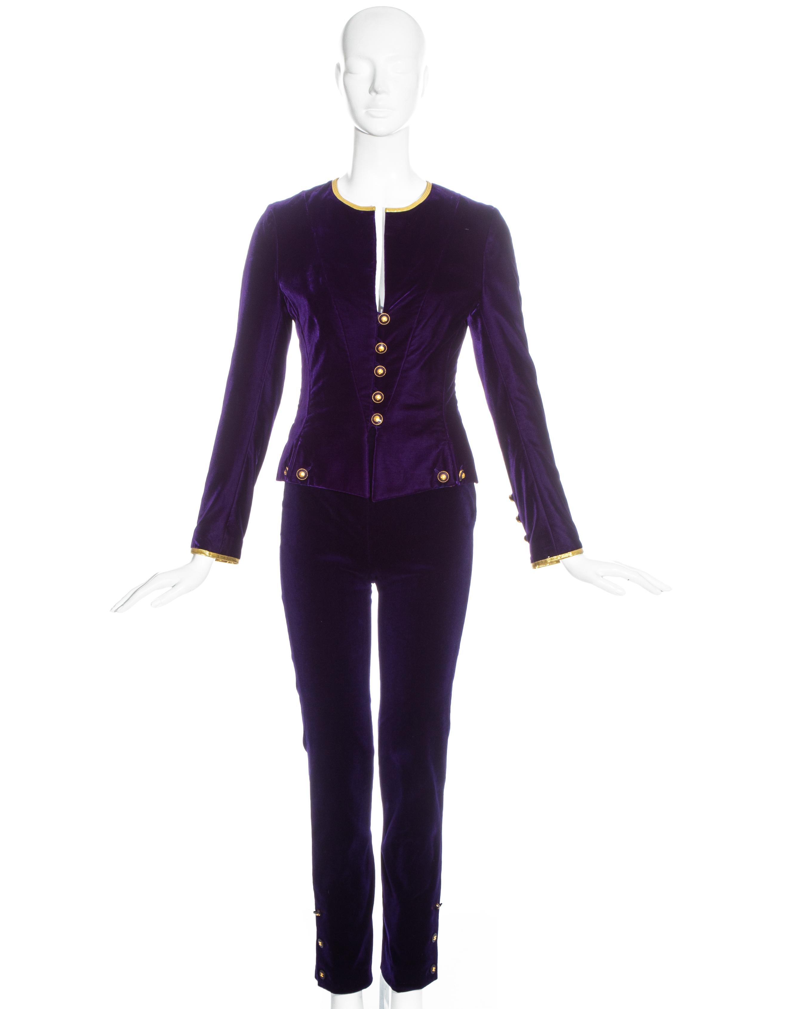 Chanel by Karl Lagerfeld, purple velvet pant suit comprising: fitted jacket with metallic gold trim, gold chanel button closures and silk lining; high waisted fitted pants with chanel button closures on the side. 

Fall-Winter 1993