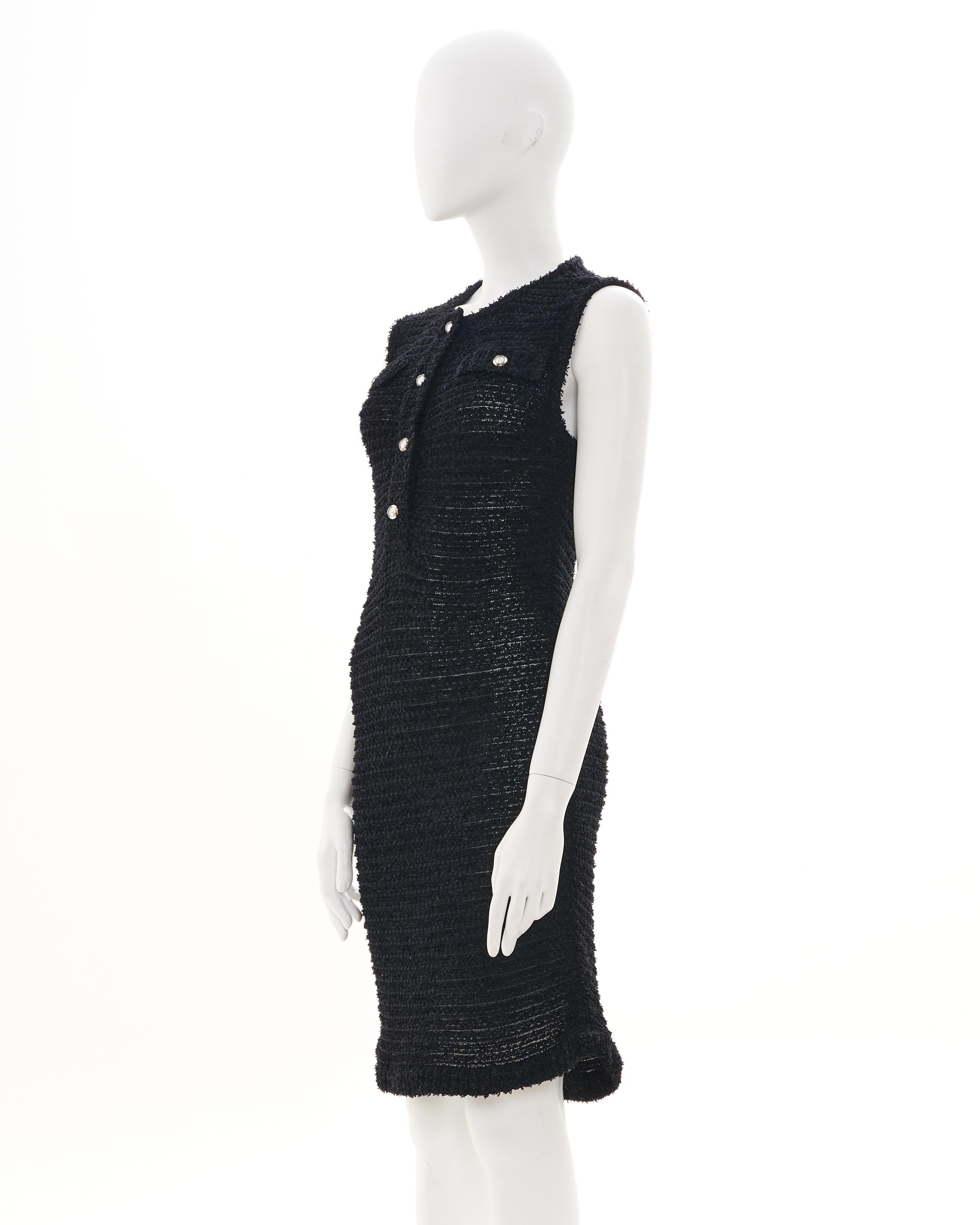 - Designed by Karl Lagerfeld
- Sold by Skof.Archive
- Resort 2016
- Chanel black boucle open knit sheer dress
- Sleeveless with a henley neckline and faux flap pockets 
- The black is contrasted by the pearl logo buttons encased in lucite
- Can be