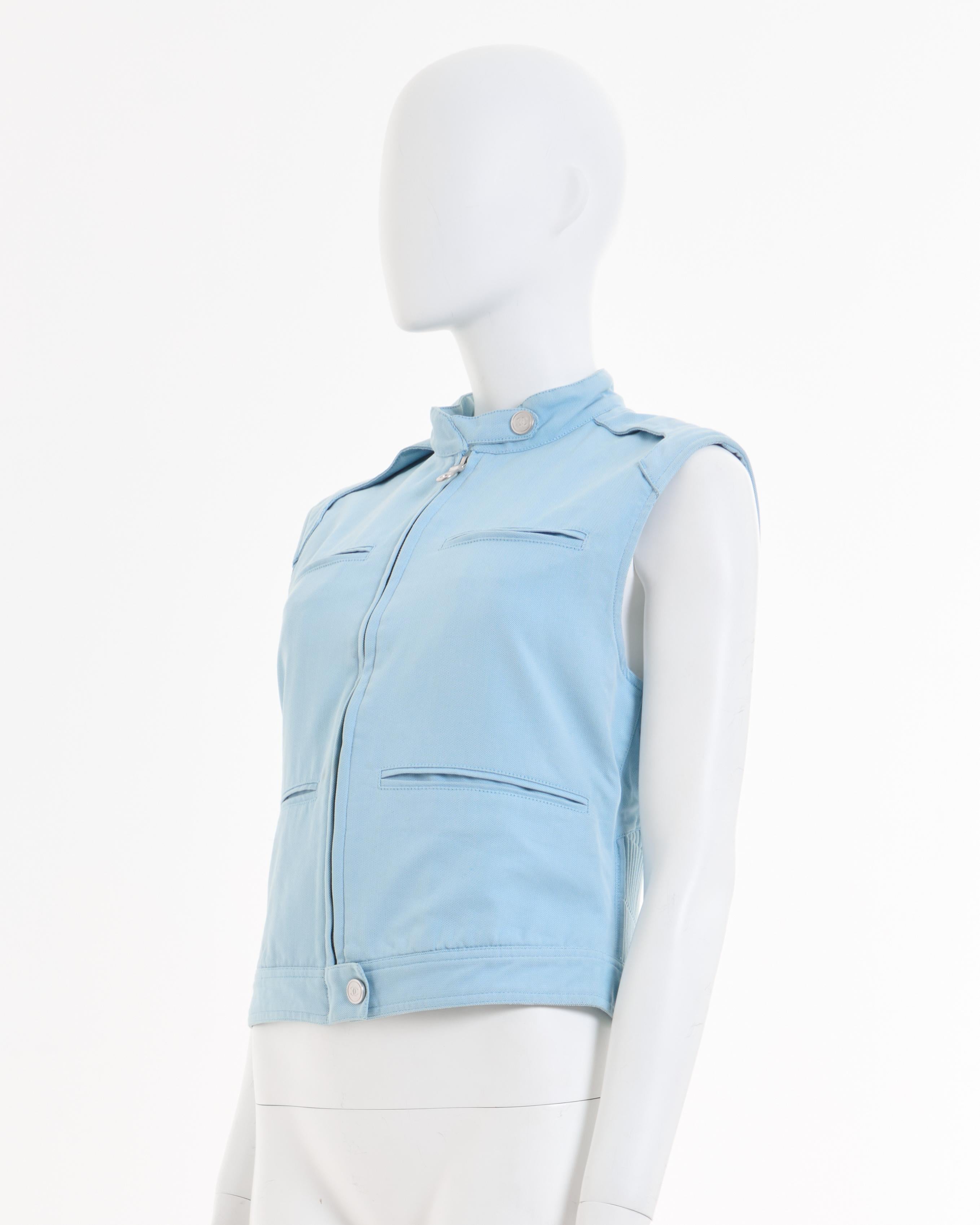 - Chanel light blue motorcycle vest 
- Sold by Skof.Archive
- Designed by Karl Lagerfeld
- Spring-Summer 2002 
- Derriere sport collection 
- Frontal zipper closure with metal snap buttons with CC logo engraved 
- Sleeveless 
- Back red embroidery