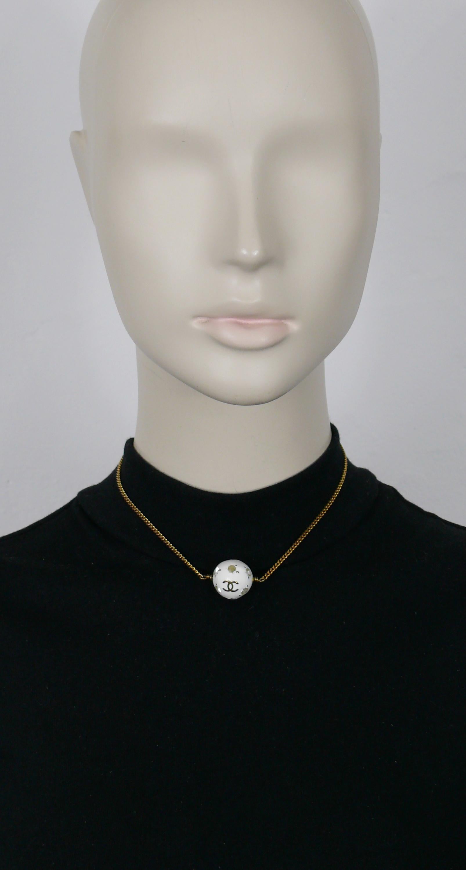 CHANEL by KARL LAGERFELD gold tone chain necklace featuring a white and clear resin soccer ball with 2 CC logos. 

Designed on the occasion of the 1998 FIFA World Cup in France.

Adjustable hook clasp closure.

Embossed CHANEL 98P Made in