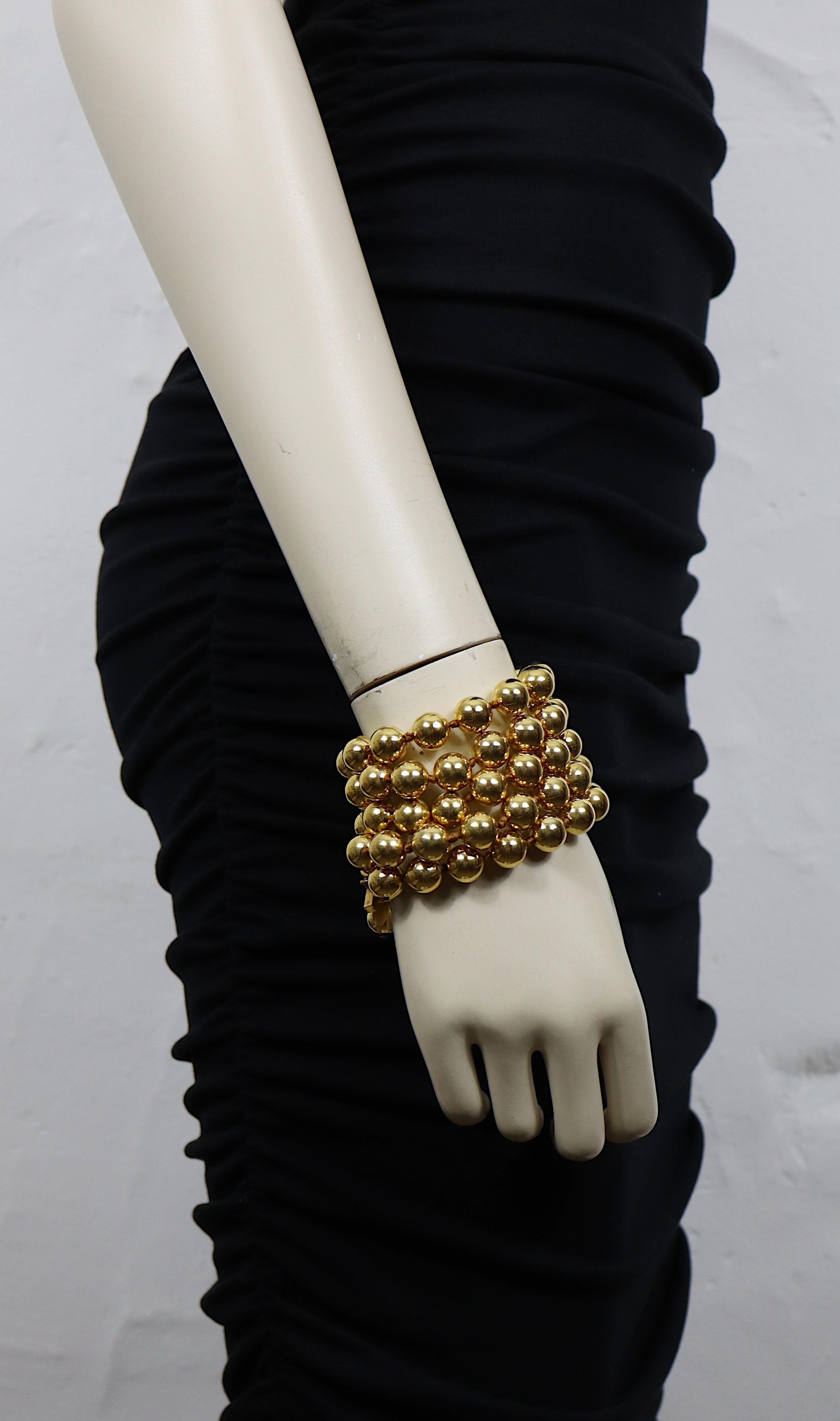 CHANEL by KARL LAGERFELD vintage gold tone five-strand cuff bracelet featuring metal beads.

Double hook clasp closure.
Adjustable length.

Collection n°25 (year : 1990).
Jewelry creative director : VICTOIRE DE CASTELLANE.

Embossed CHANEL 2 5 Made
