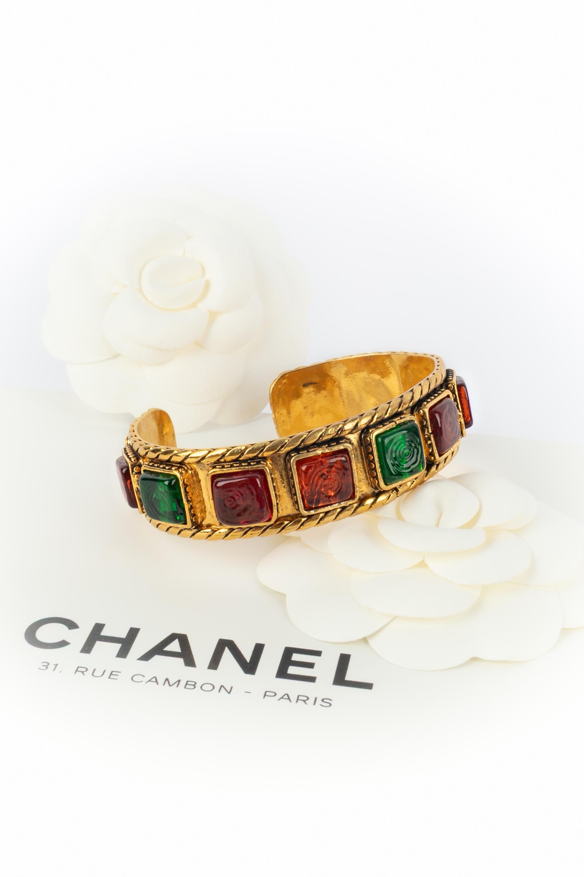 CHANEL - (Made in France) Golden metal rigid bracelet ornamented with colorful glass paste cabochons. A 2cc3 Collection under the artistic direction of Karl Lagerfeld.

Condition:
Very good condition

Dimensions:
Circumference: 16 cm - Opening: 3 cm