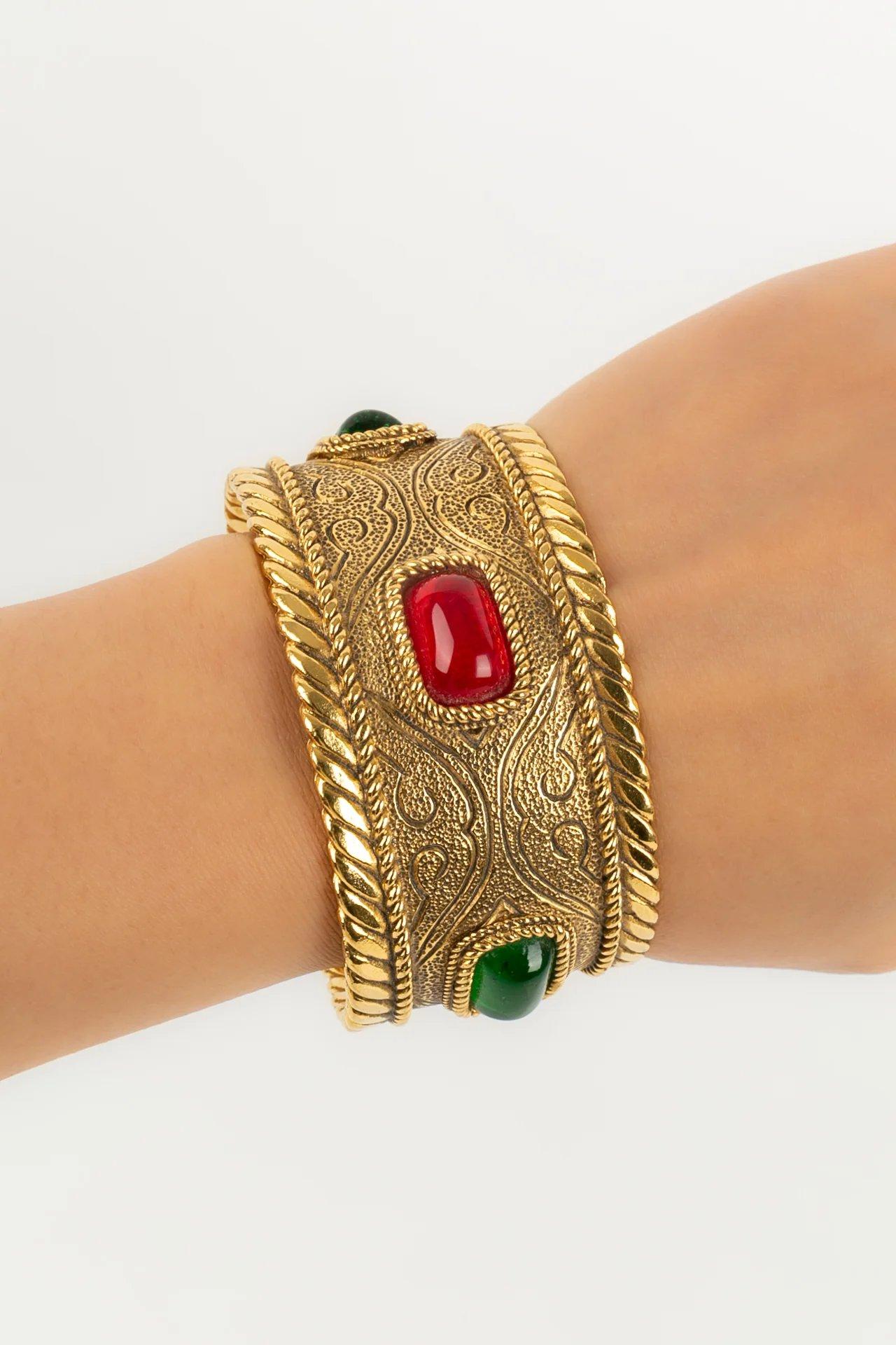 Chanel - (Made in France) Bracelet in gilded metal and cabochons in glass paste. Collection 1985.

Additional information:
Dimensions: Circumference: 14.5 cm 
Opening: 3 cm 
Width: 3.5 cm
Condition: Very good condition
Seller Ref number: BRAB51