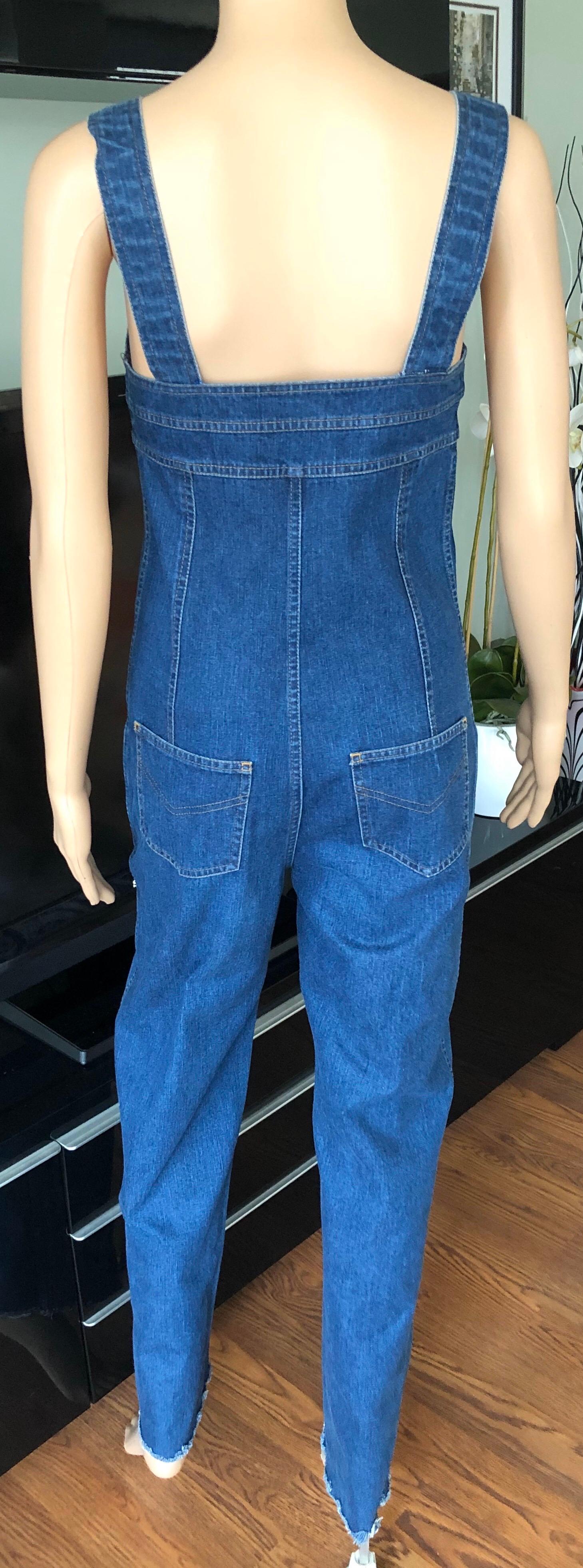 Chanel c. 1990 Vintage Blue Denim Overalls Romper Jumpsuit FR 36

Chanel blue medium wash denim jumpsuit featuring contrast stitching throughout, raw edge hem and zip closure at front with additional cc logo button closures.