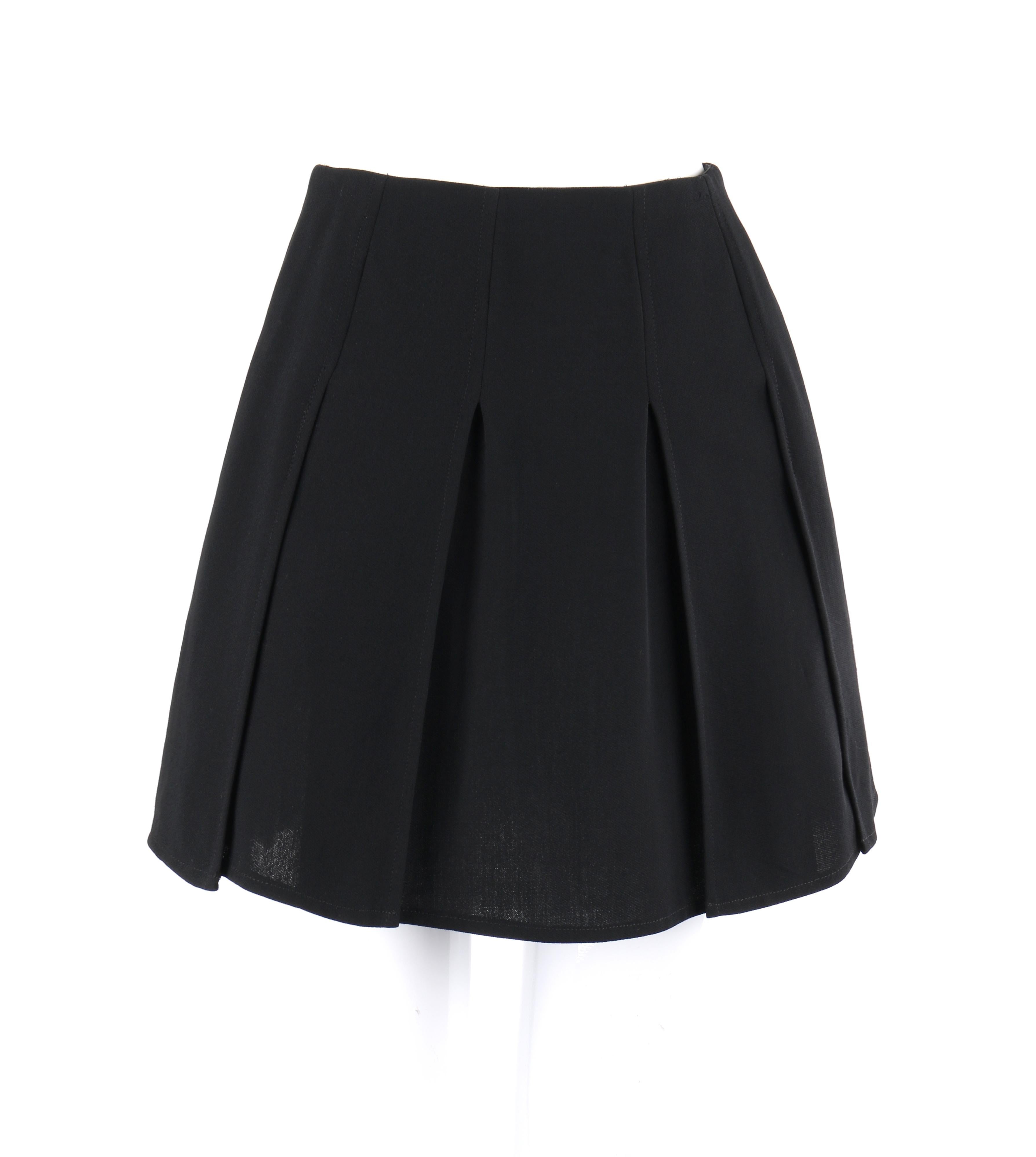 CHANEL c.1980’s Boutique Classic Black Wool Panel Pleated Mini Skirt
 
Circa: 1980’s
Label(s): Chanel Boutique
Style: Mini skirt
Color(s): Black
Lined: No 
Unmarked Fabric Content: Wool 
Additional Details / Inclusions: individual panels; pleated;
