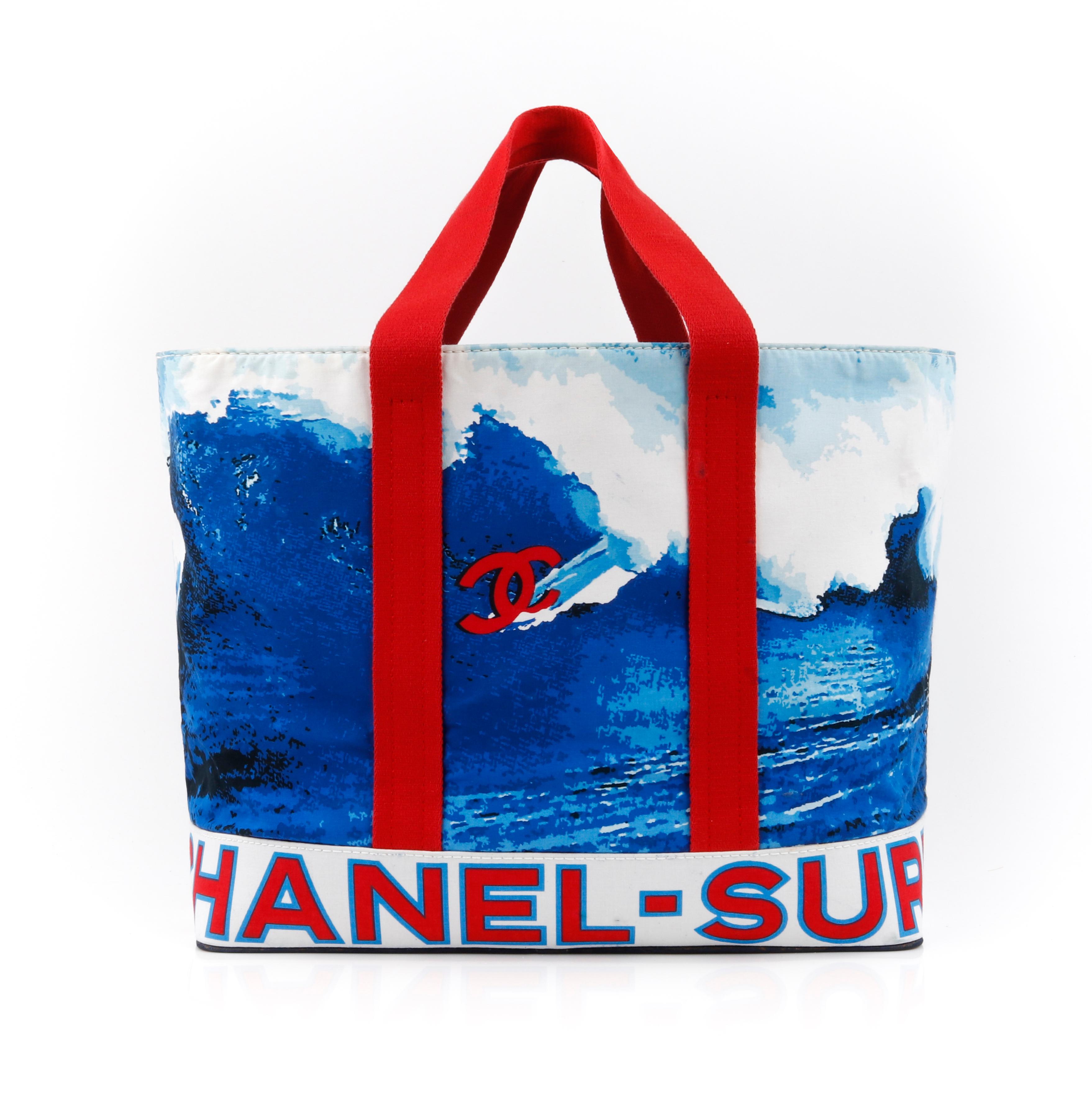 CHANEL c.2002 Red White Blue CC Surf Wave Canvas Beach Bag Large Tote
 
Brand / Manufacturer: Chanel
Style: Beach bag / Tote
Color(s): Shades of red, white and blue. 
Unmarked Materials: Canvas (exterior), Coated Canvas (base).
Additional Details /