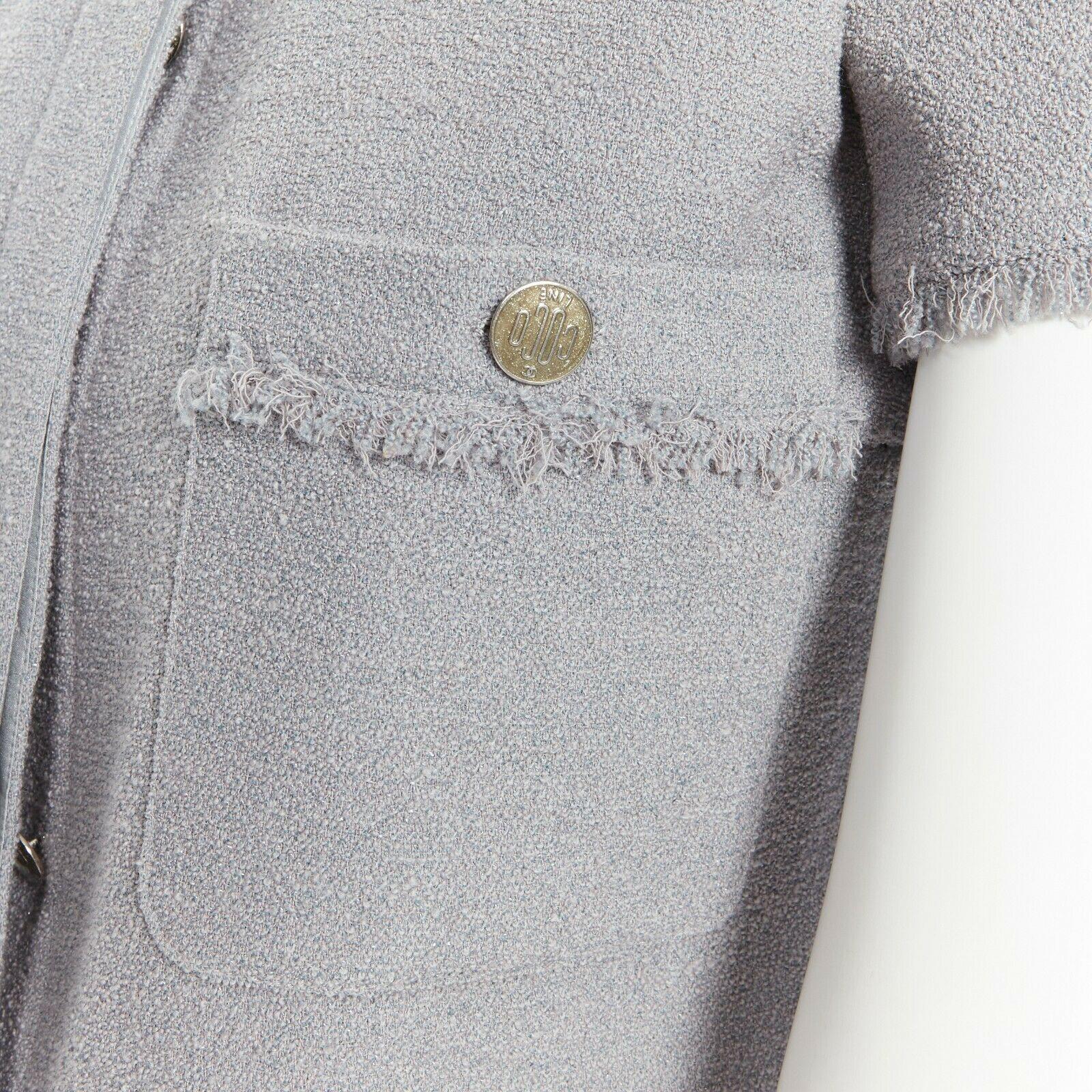 CHANEL cadet grey short sleeves slim-fit frayed hem summer tweed jacket FR 34 XS

CHANEL
Sparkly cadet grey. Wool and nylon tweed mixed. Slim-fit silhouette. Short sleeves. Collarless rounded neckline. Frayed hems. Decorated with silver buttons.