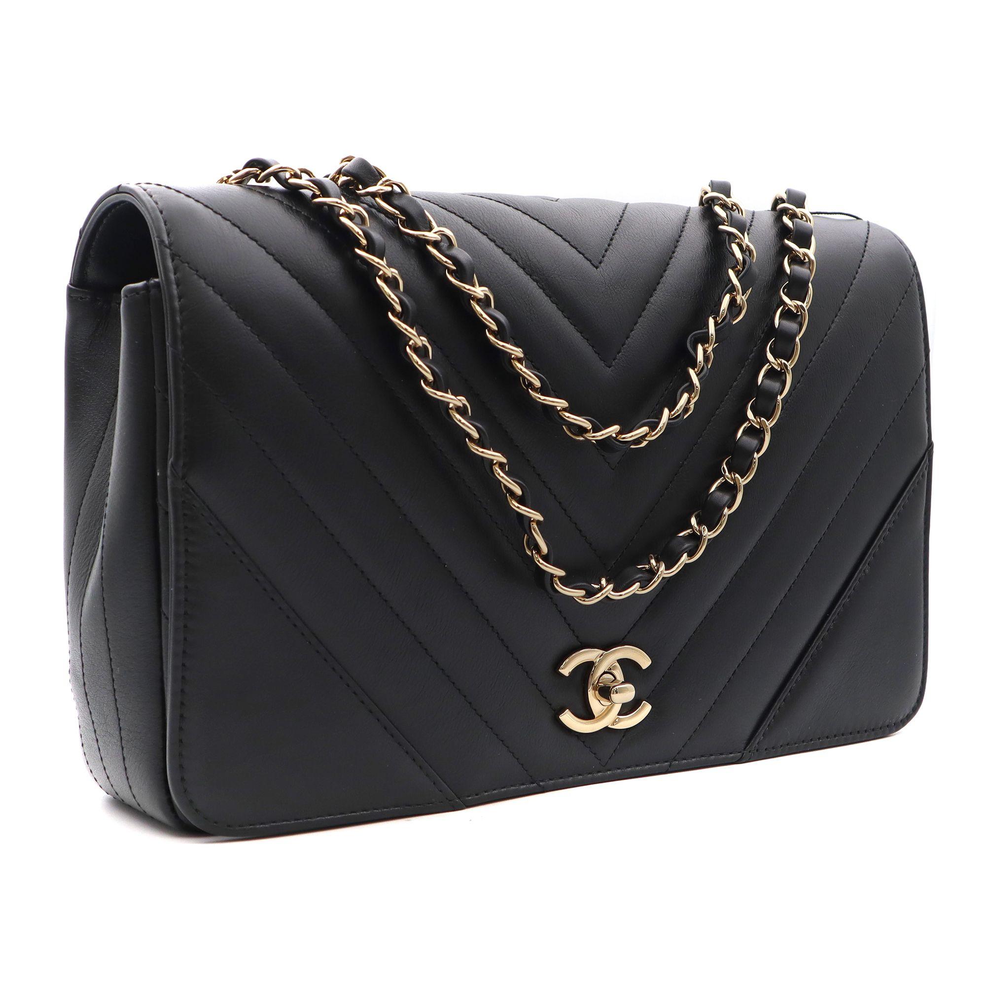 This Chanel shoulder/crossbody bag is crafted of chevron calfskin leather in black color. The bag features light gold chain link leather threaded shoulder straps and a full frontal flap with a light gold Chanel CC turn lock. It opens to a black
