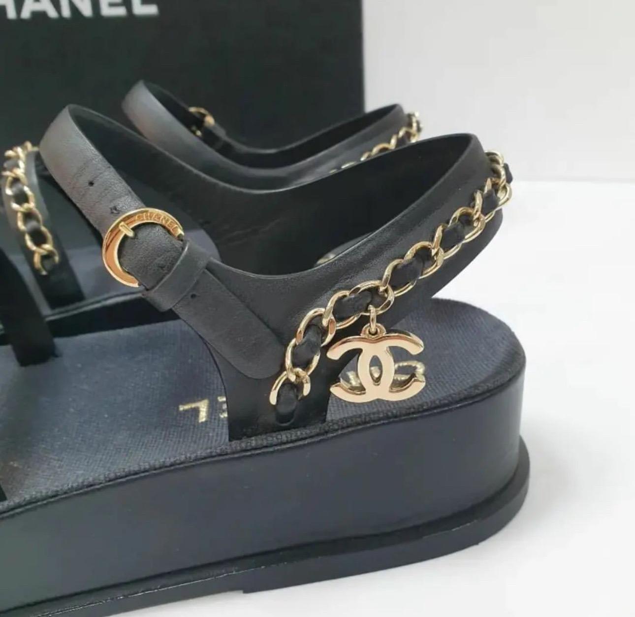 This is an authentic pair of CHANEL Calfskin Chain Platform Sandals  in black. 
These stylish sandals are crafted of classic black calfskin leather and feature gold leather threaded chain link straps.
 Sz.36
Very good condition.
No box. No dust bag.