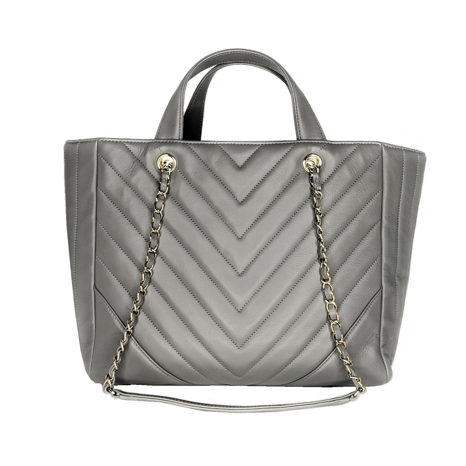 This stylish tote is beautifully crafted of chevron-quilted calfskin leather in Grey. The shoulder bag features polished gold-tone chain link leather threaded shoulder straps with leather shoulder pads and leather top strap handles. The top opens
