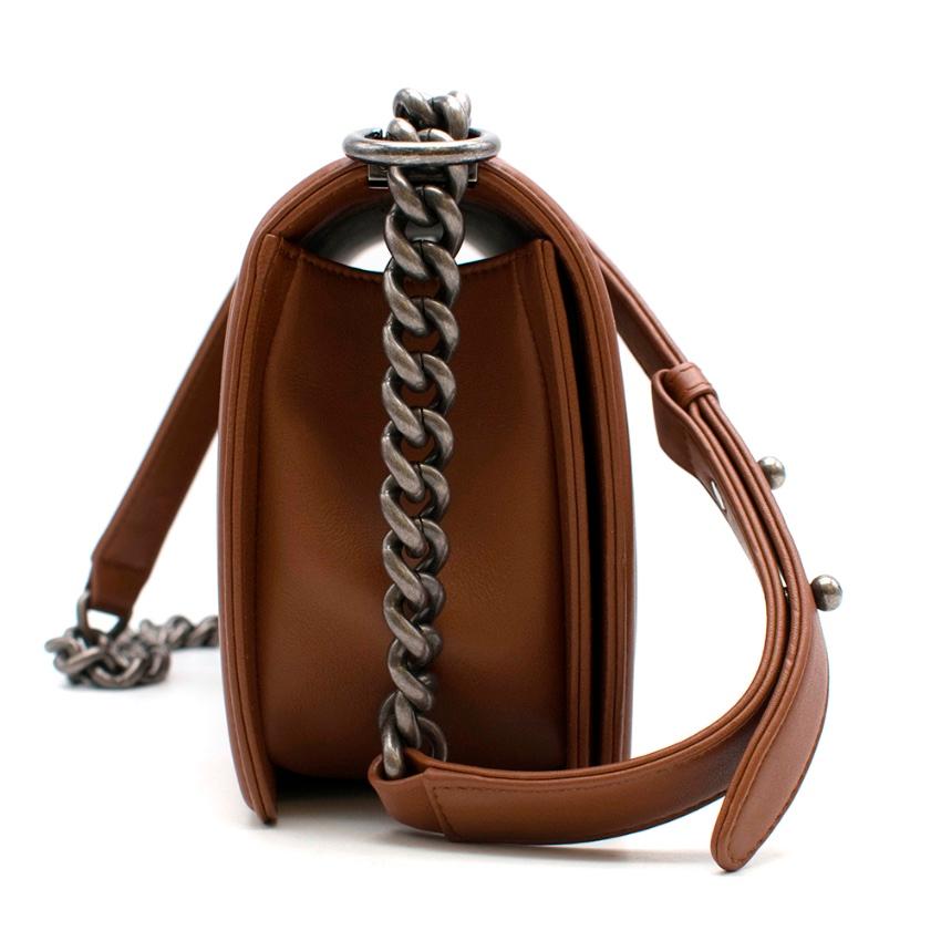Chanel Calfskin Embossed Medium Cordoba Brown Boy Bag 

This chic bag is crafted of embossed calfskin leather in brown framed by a linear quilting. The bag features a ruthenium chain shoulder strap with a leather shoulder pad and a frontal ruthenium