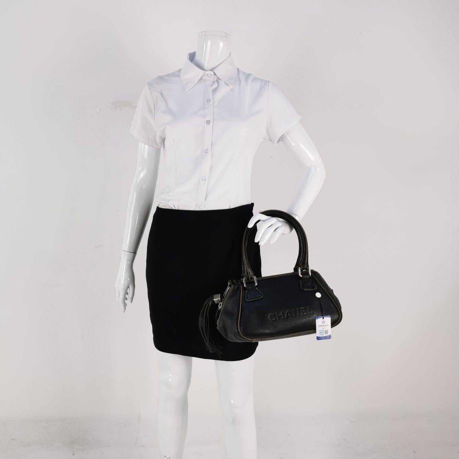 CHANEL Calfskin Leather Tassel Medium Black Bowler bag In Good Condition In AUBERVILLIERS, FR