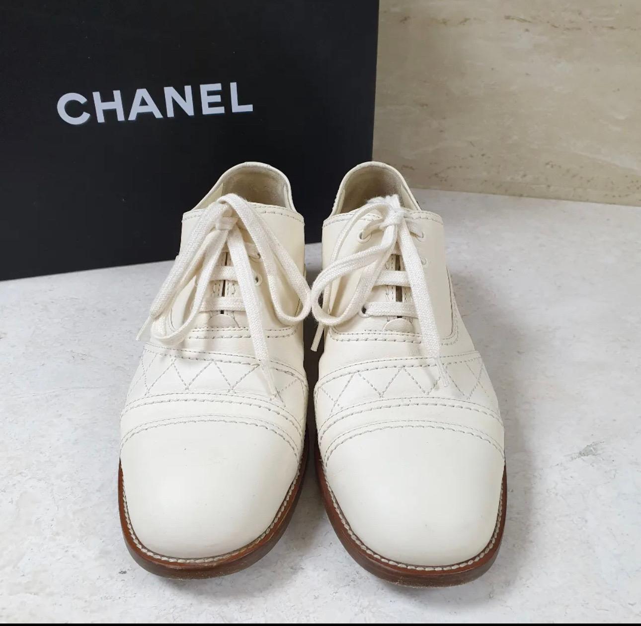 This is an authentic pair of CHANEL Calfskin Quilted CC Lace Up Oxfords 
Sz.37.5 
Ivory colour
These chic loafers are crafted of calfskin leather.
 They feature a rounded toe, a quilted design on the sides and white laces.
 These classic shoes have